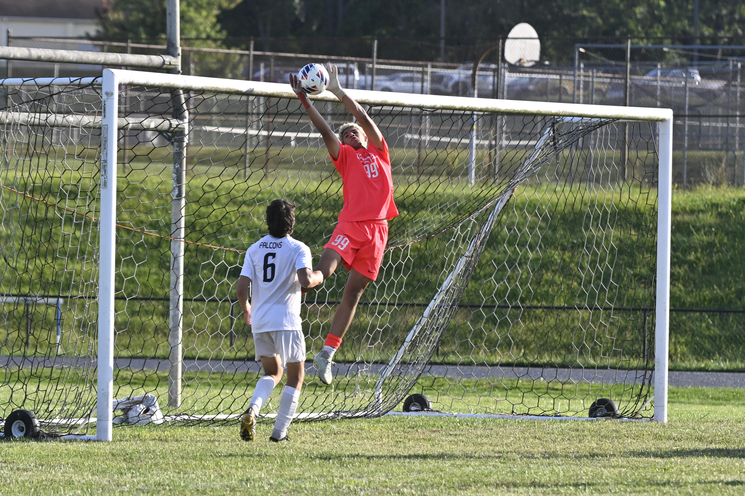 Gerstell goalie Preston Harris leaps high to grab the ball...