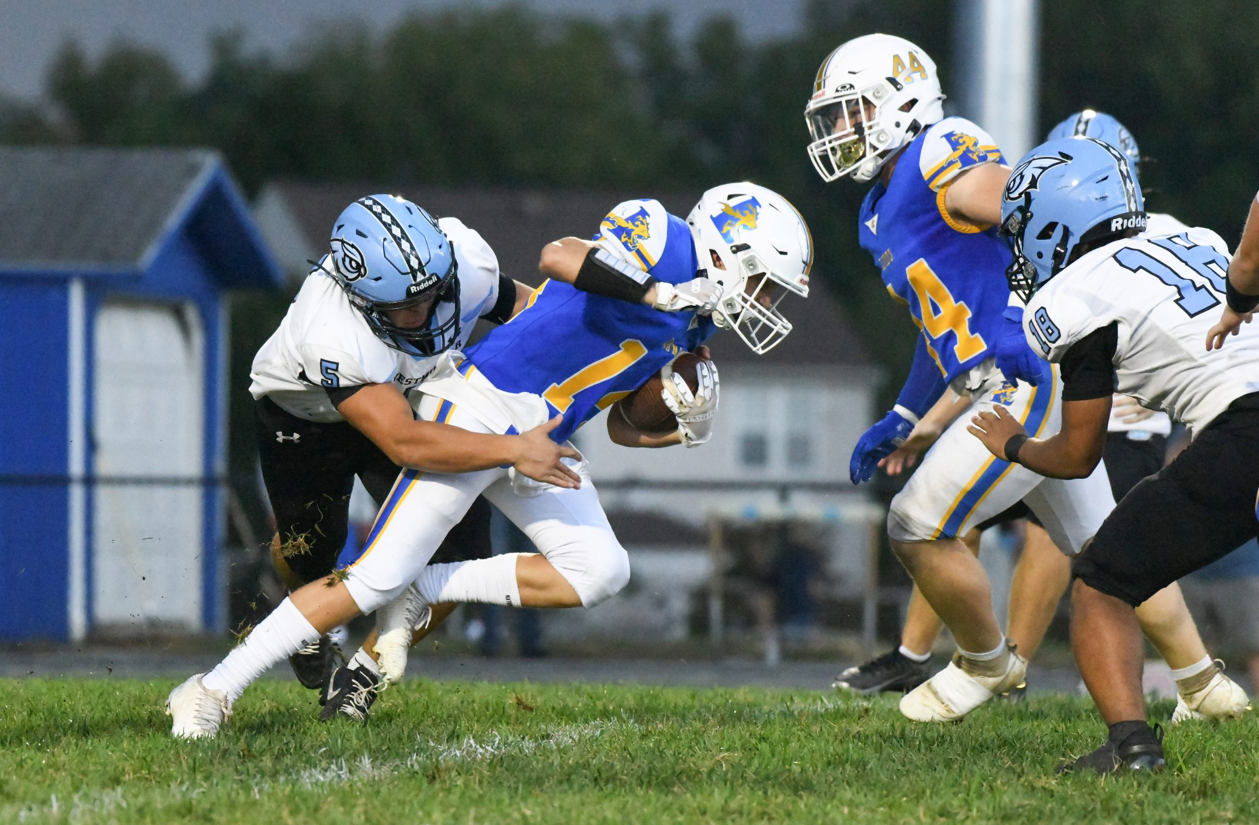 Westminster's Gabriel Lee, left, tries to tackle Liberty's Callum Greco...