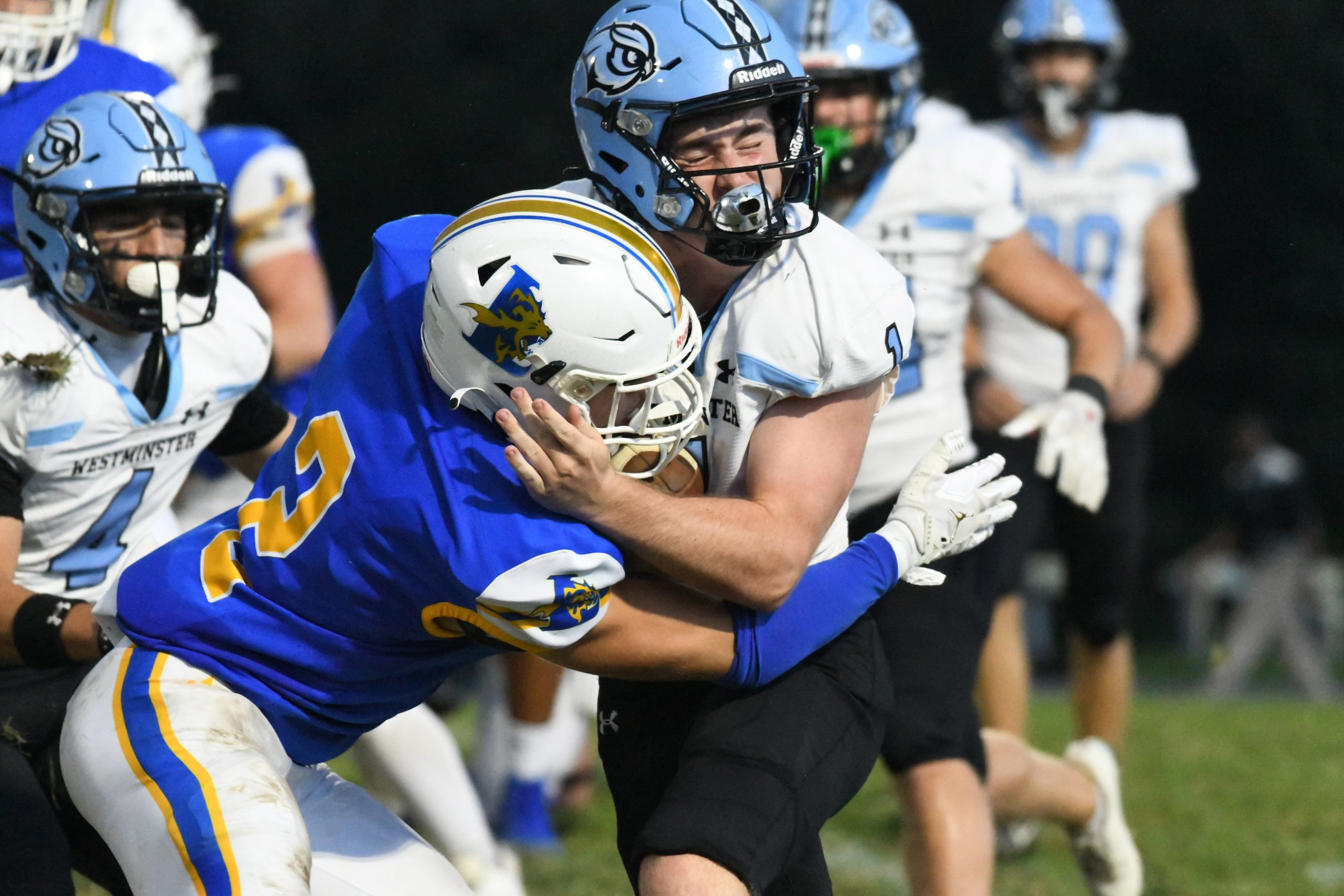 Westminster's Rory O'Connor takes a hit from Liberty's Charlie Frothingham...