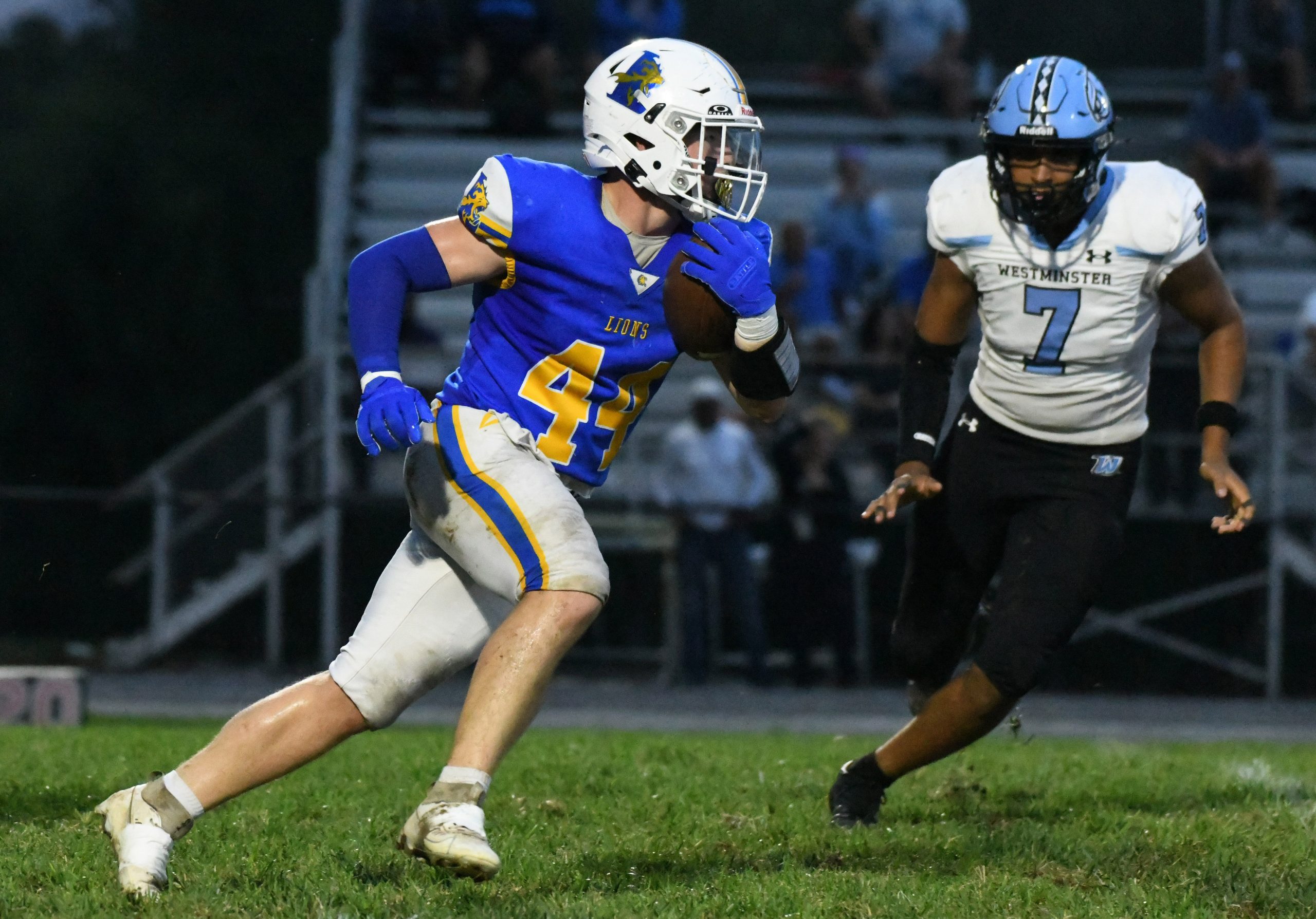 Liberty's Kevin Kern runs with the ball as Westminster's Isaiah...