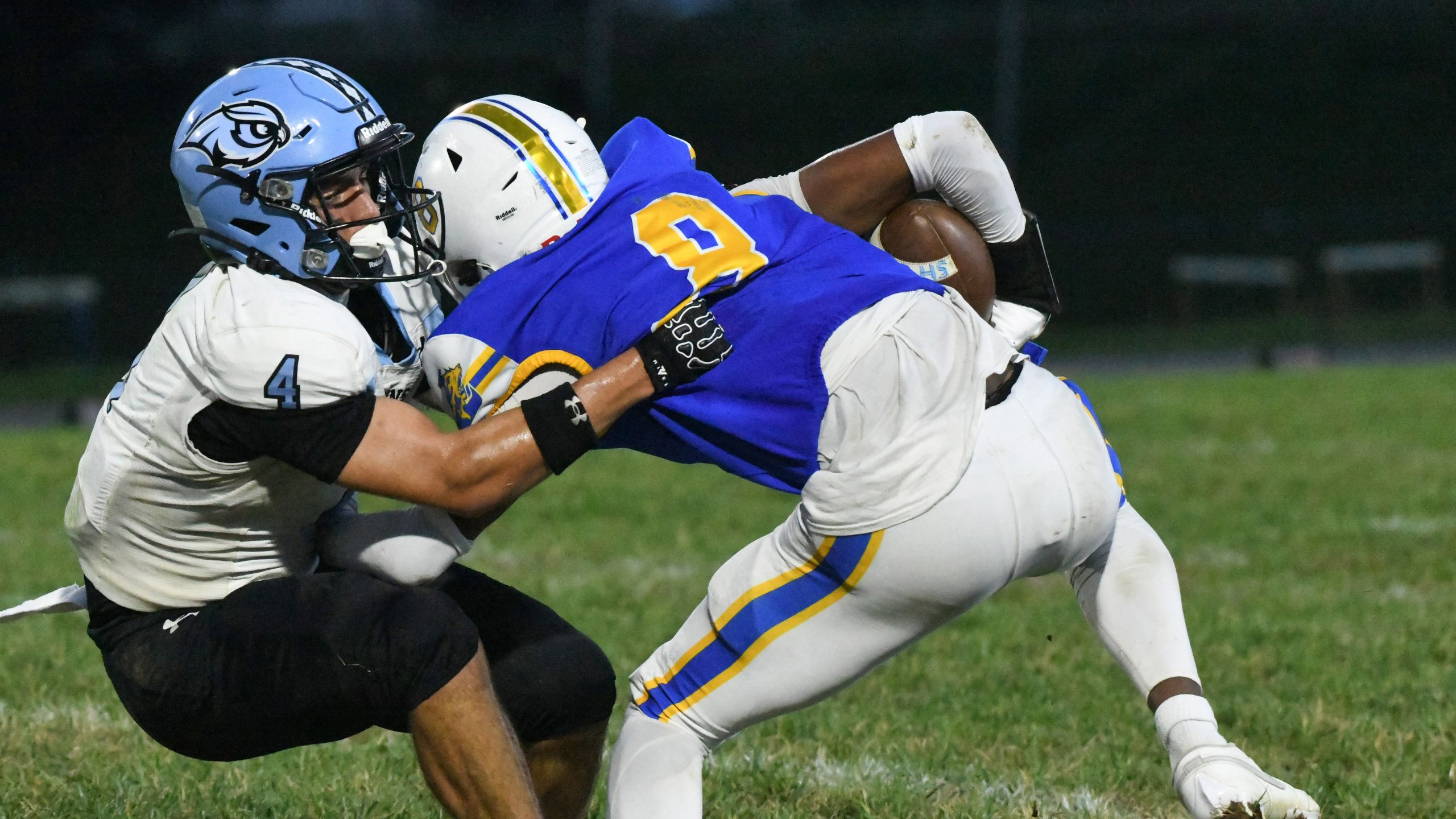 Westminster's Xavier Howard, left, tries tackling Liberty's Stephen Puckett after...