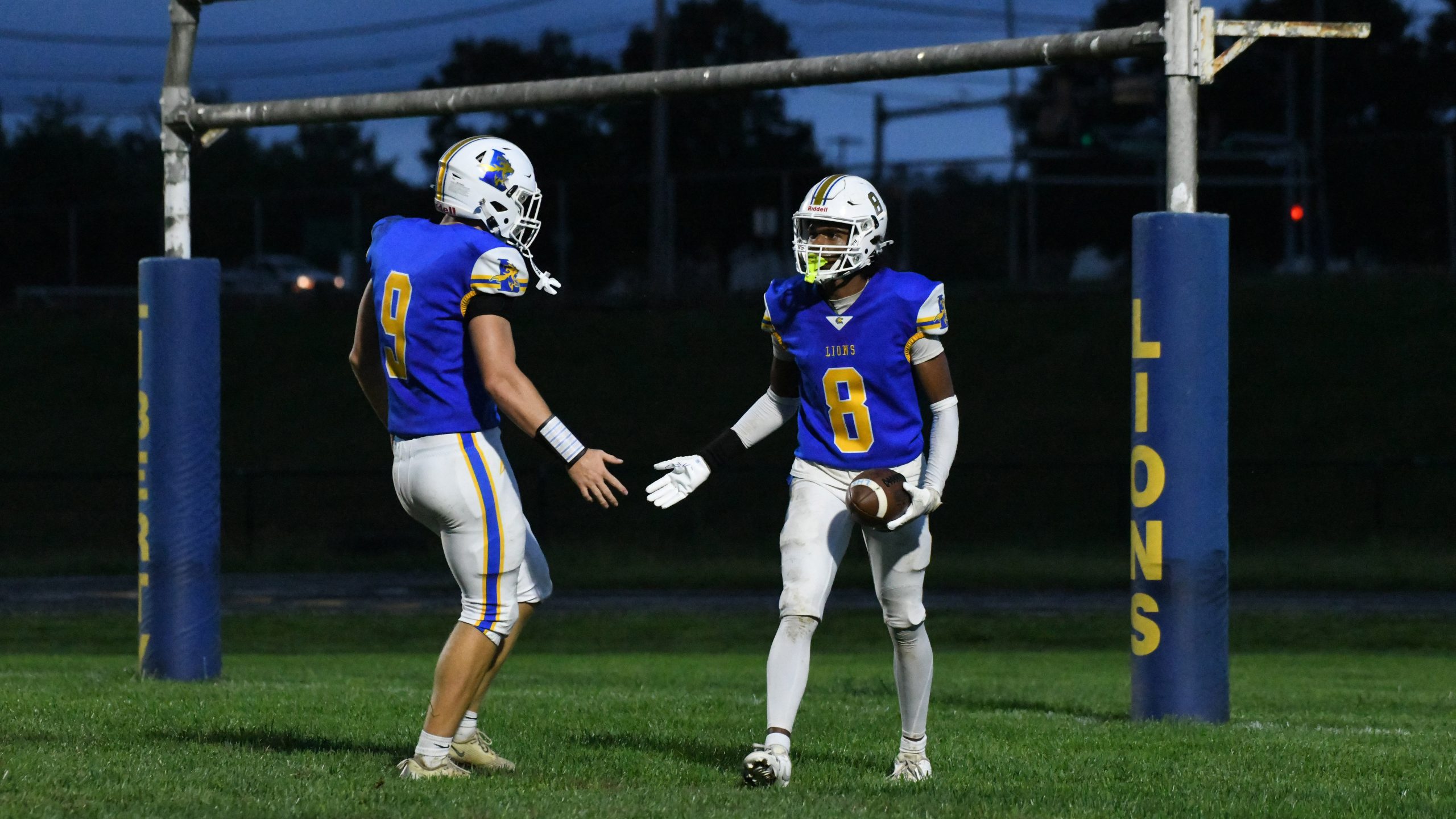Liberty's Stephen Puckett #8 celebrates a touchdown with teammate Carter...