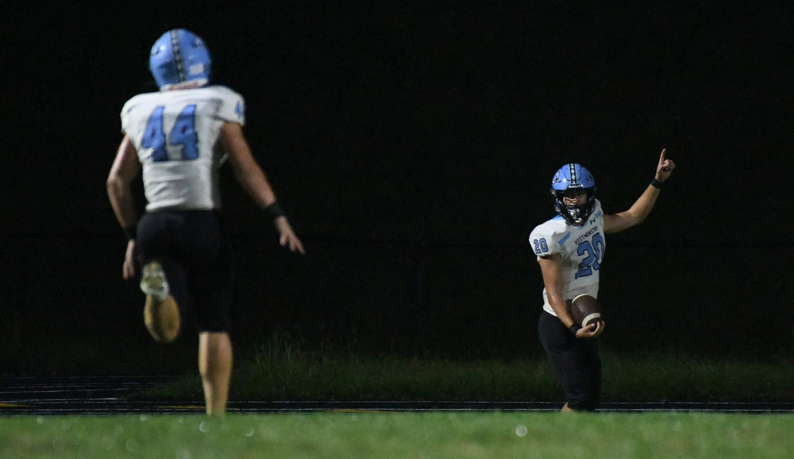 Westminster's Nick Compher #20 celebrates a long touchdown run during...