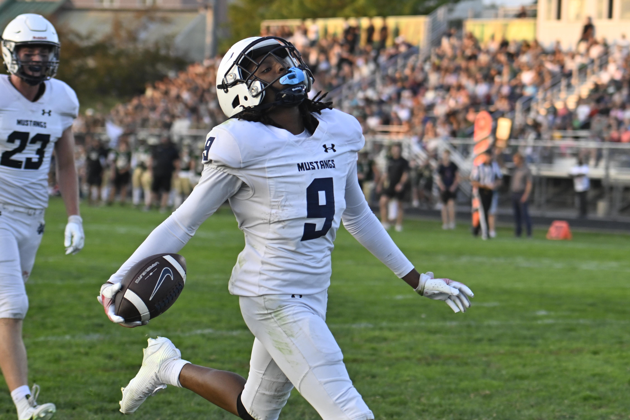 Marriotts Ridge's Emmanuel Williams scores a touchdown during a football...