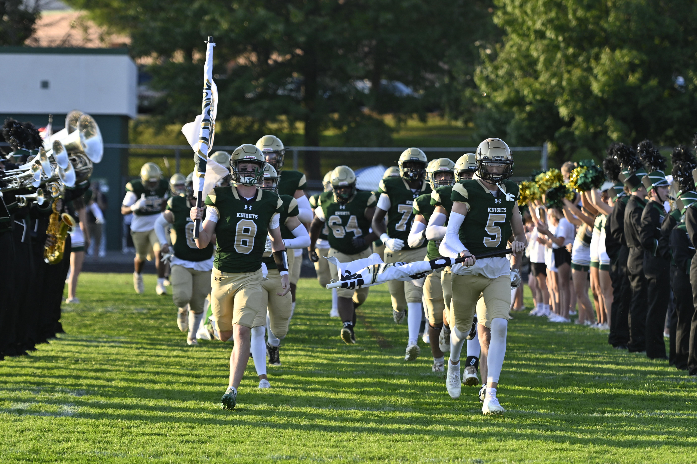Jacob Dexter, left, and Quentin Duncan lead the Knights onto...