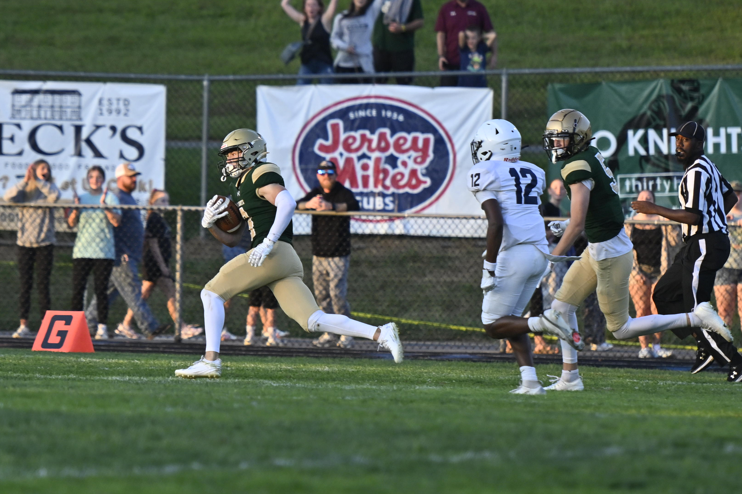 William Koenig pulls in a pass and runs for a...