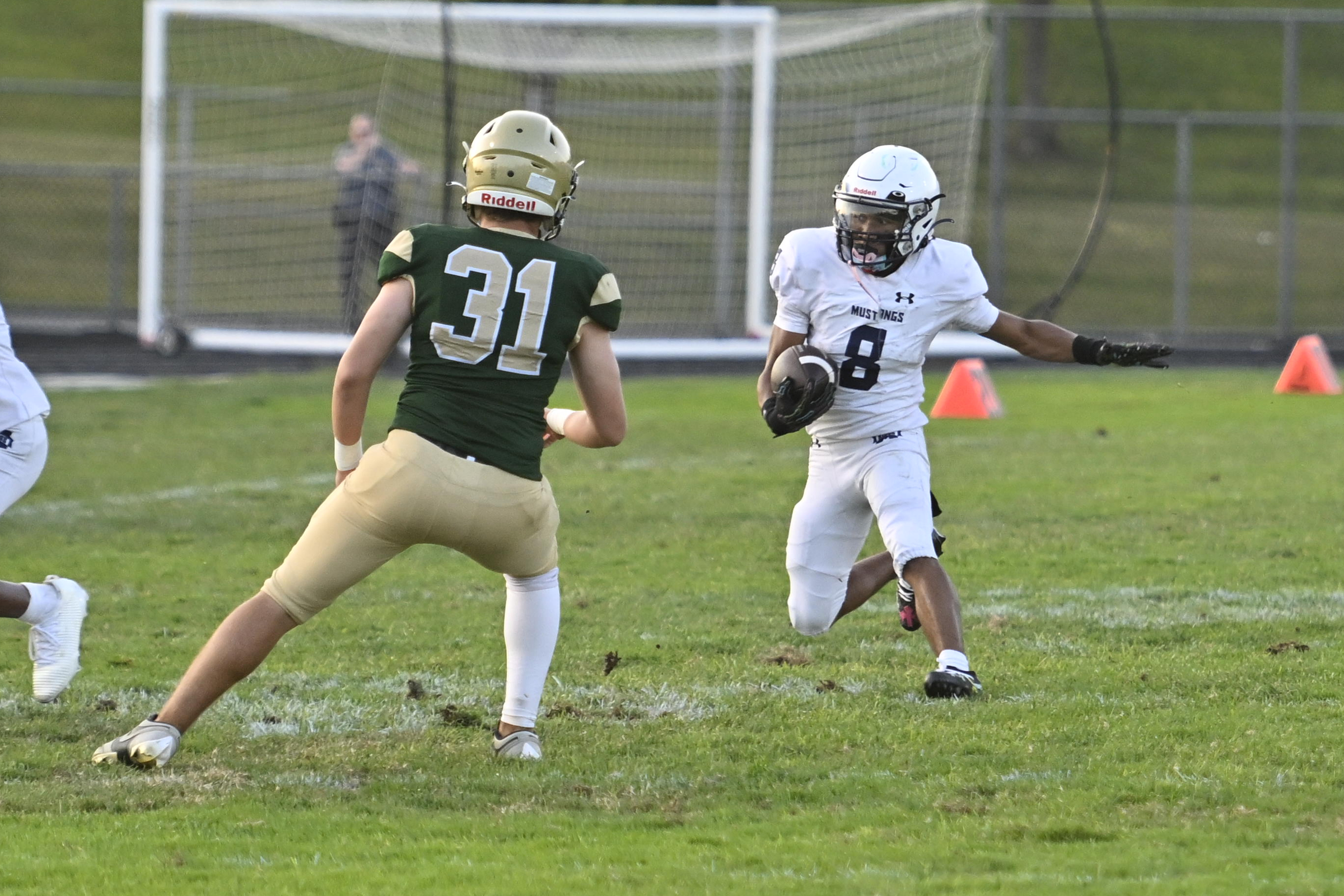 Marriotts Ridge's Rodney Butler runs the ball in front of...