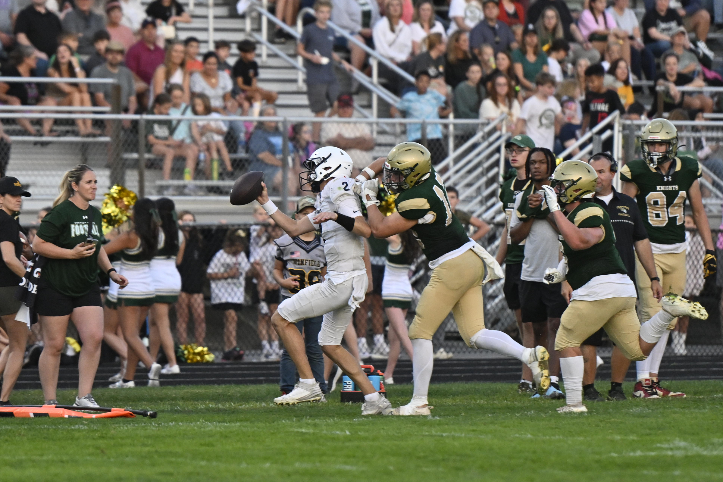 Marriotts Ridge quarterback Blake Willingham is pushed out of bounds...