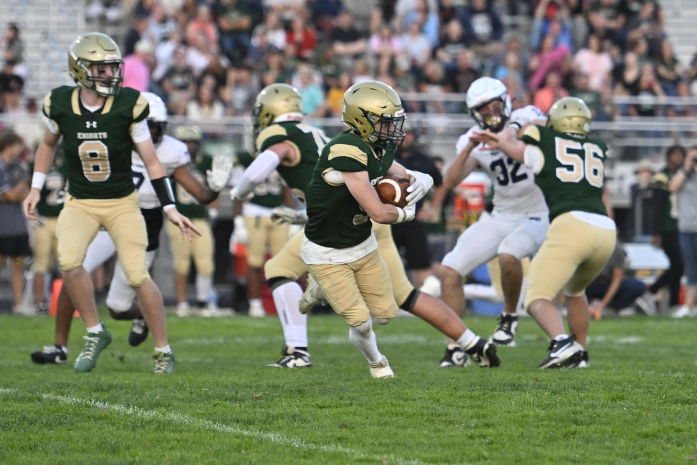 Dawson Jersey-Puga runs the ball during Friday's game. (Thomas Walker/Freelance)