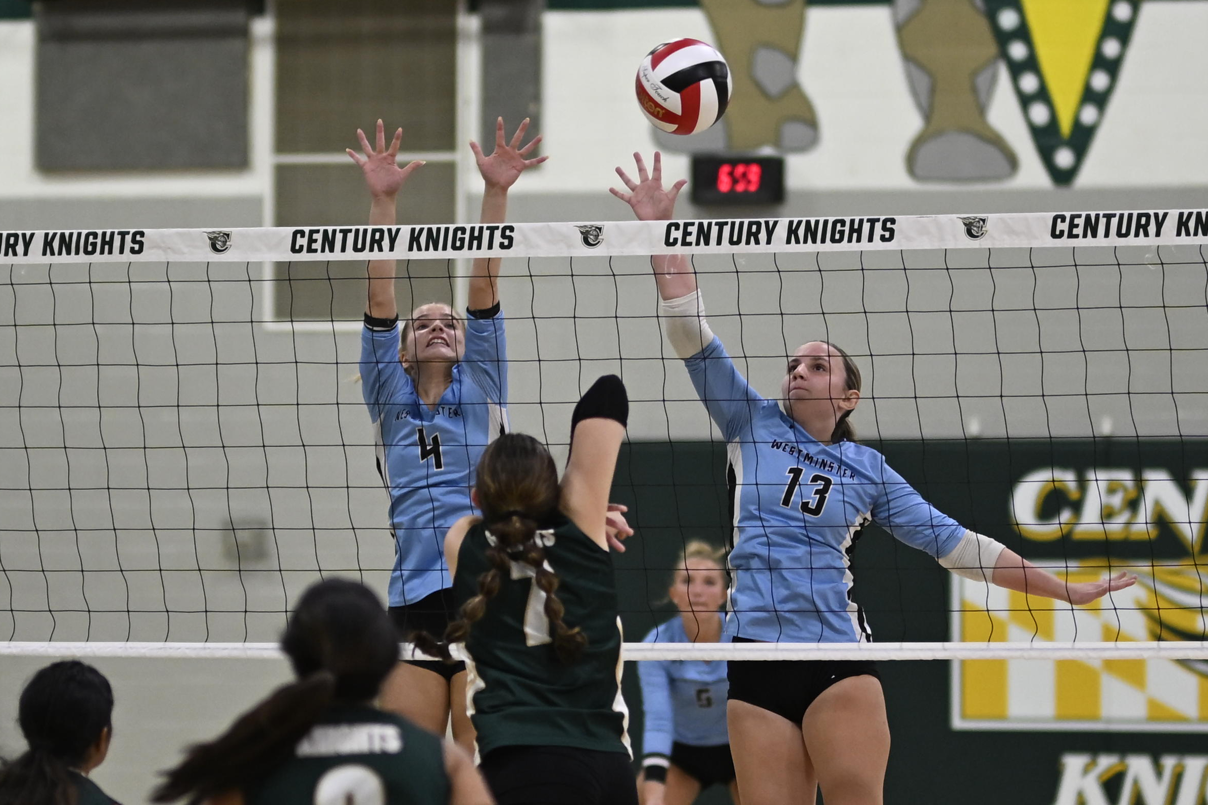 Westminster's Jaiden Hammel, left, and Allie Ryan try to block...