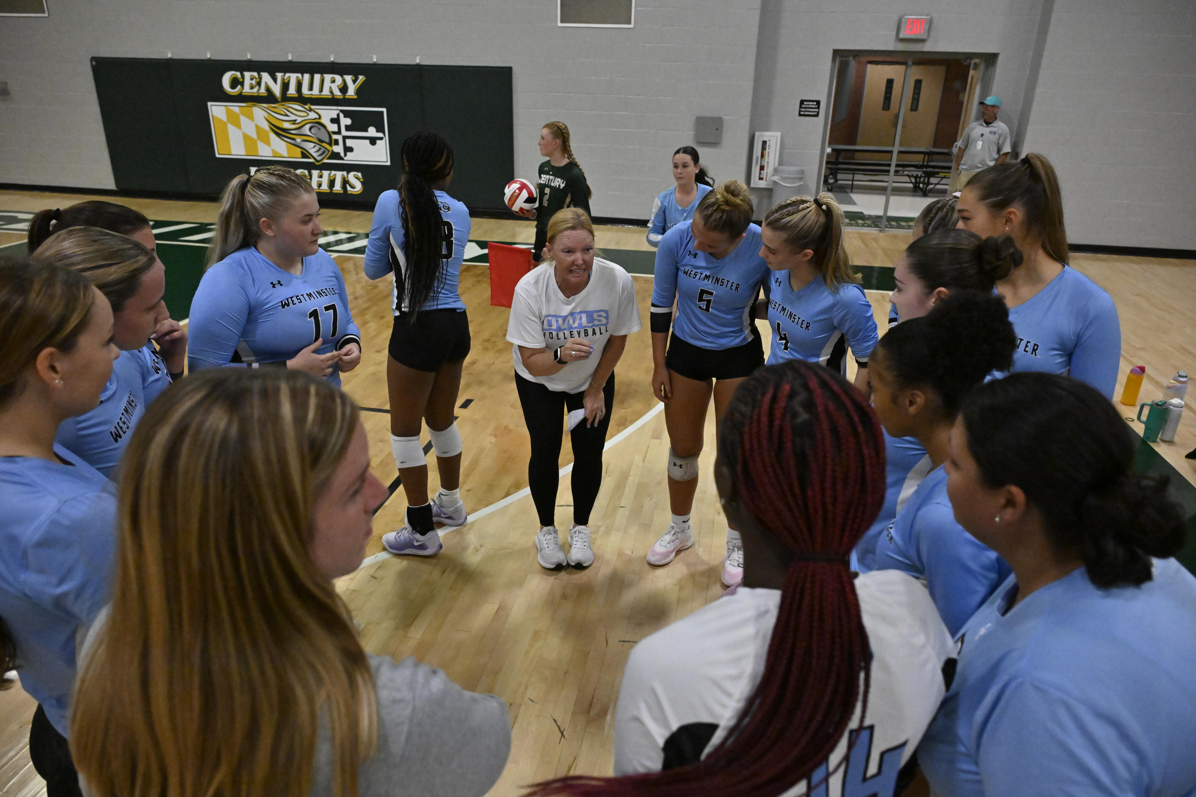 Westminster coach Bridget Griffin speaks with her team during a...