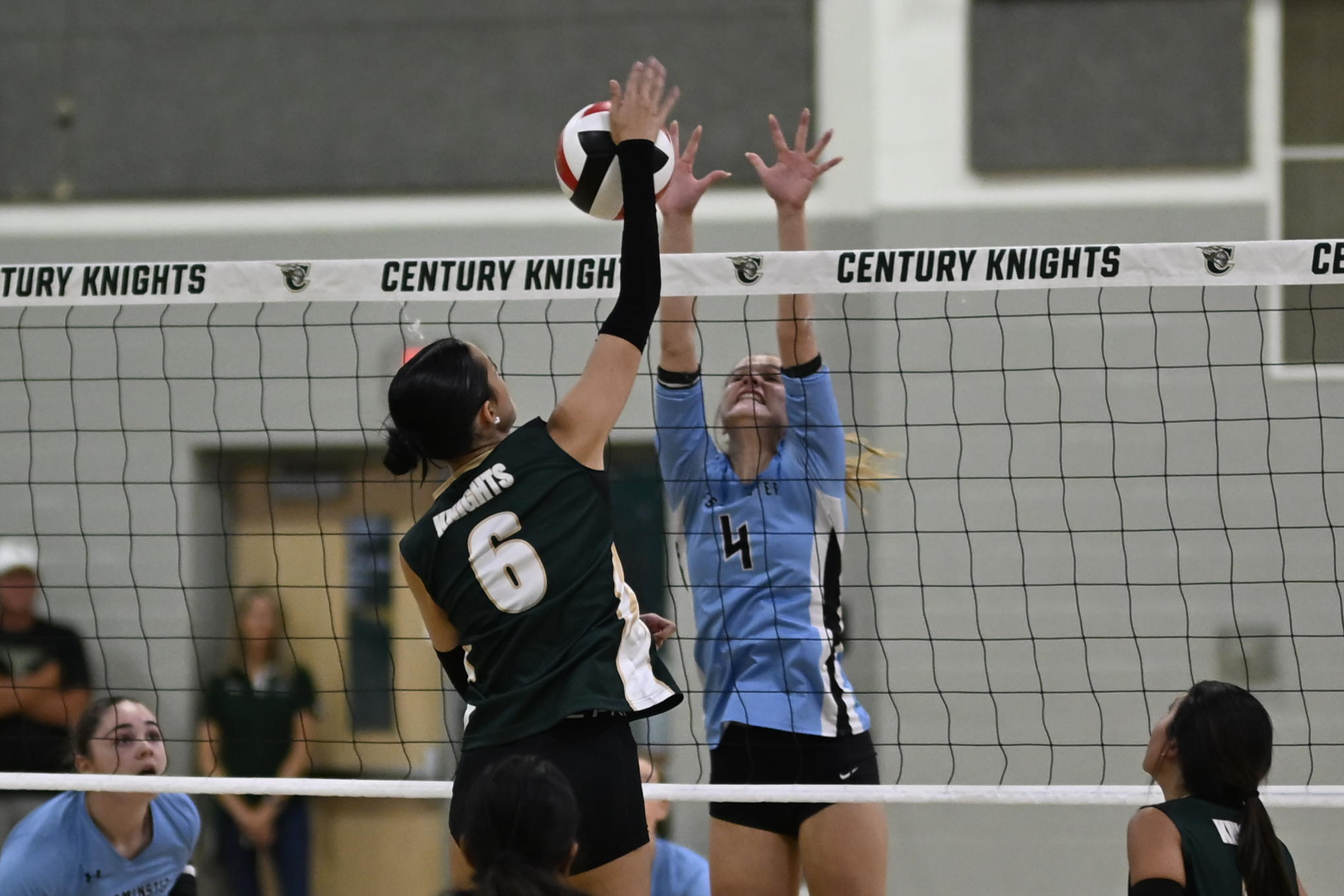 Westminster's Allie Ryan blocks a spike attempt by Natalie Perry...