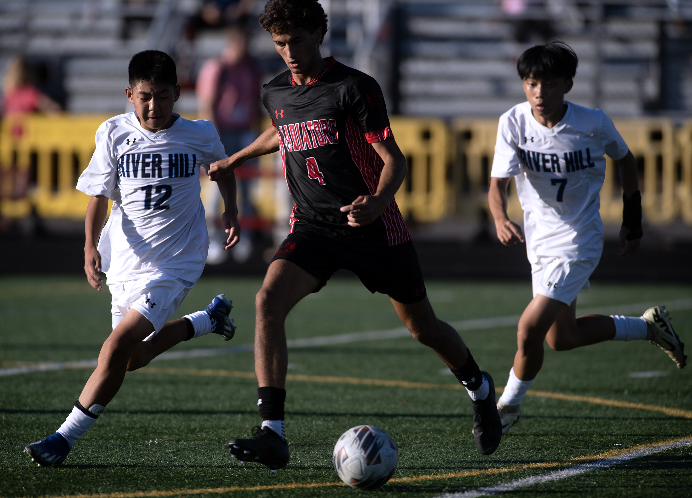 Glenelg's Vishnu Almli, center, moves the ball against River Hill's...