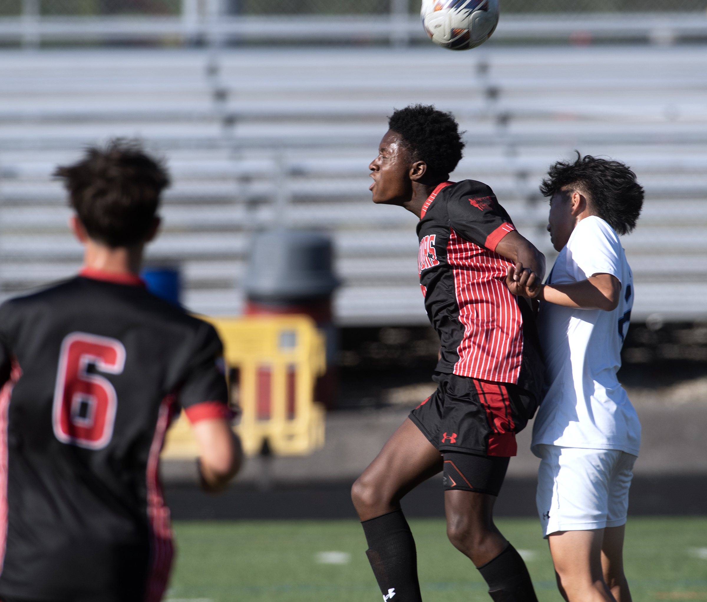 Sept. 8, 2025- Glenelg's Tito Tokunboh-Salako, center, heads the ball...