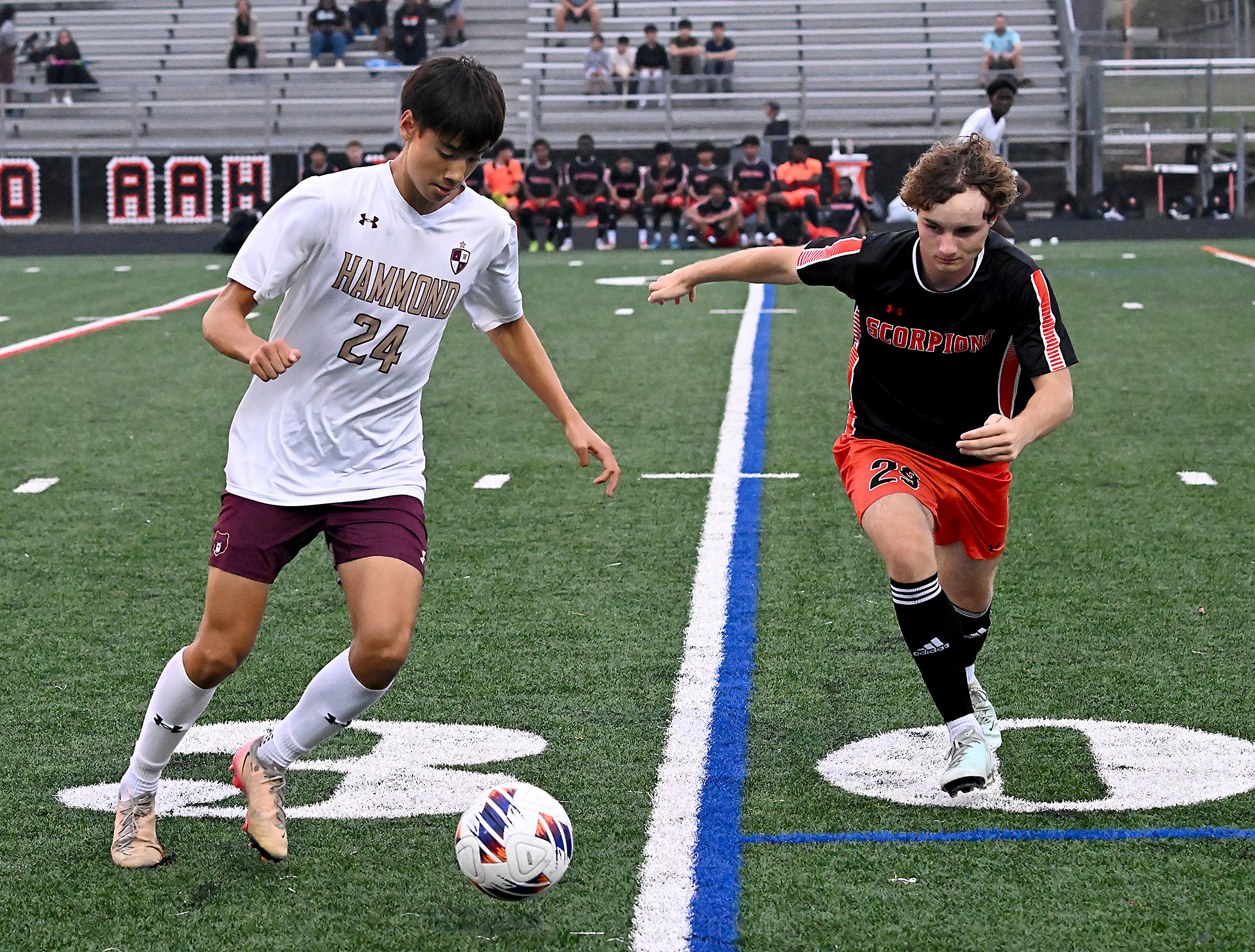 Hammond #24, Ethan Shin, looks to advance the ball in...