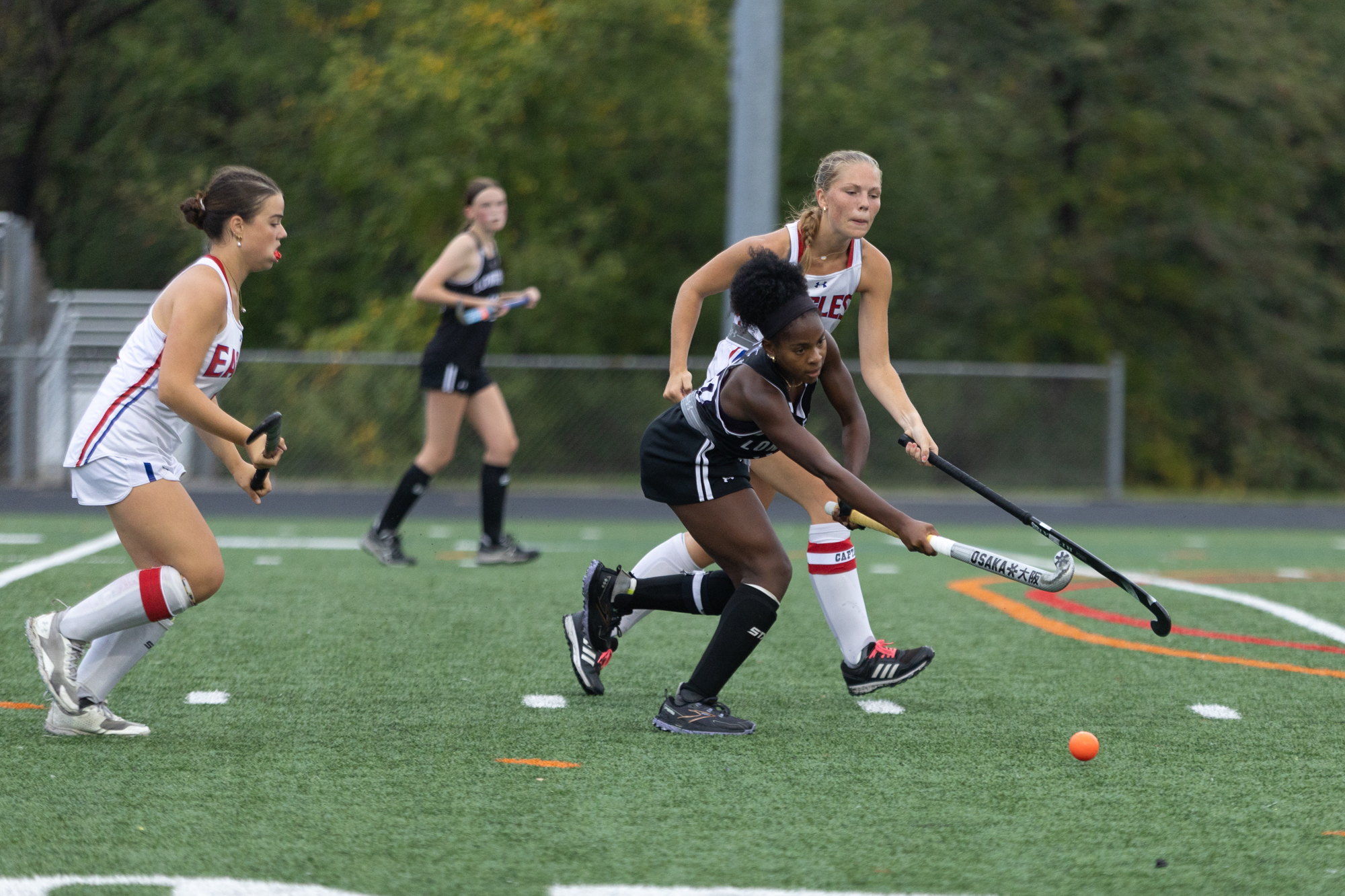Long Reach’s Leilani Stewart maneuvers the ball through Centennial defenders...