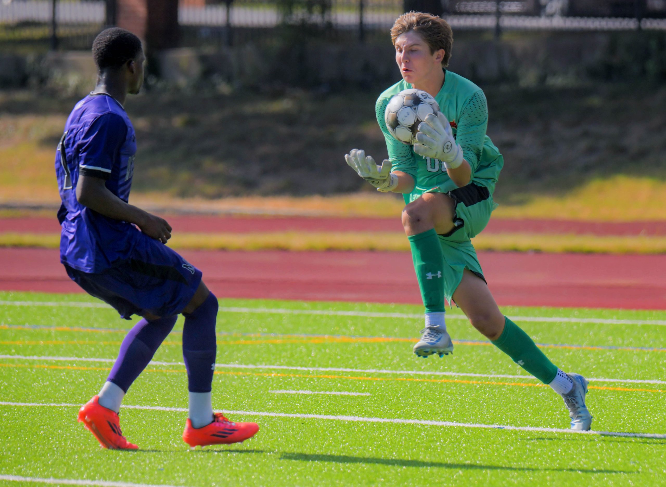 Calvert Hall Cardinals goalkeeper Enrico DiCocco grabs the ball in...