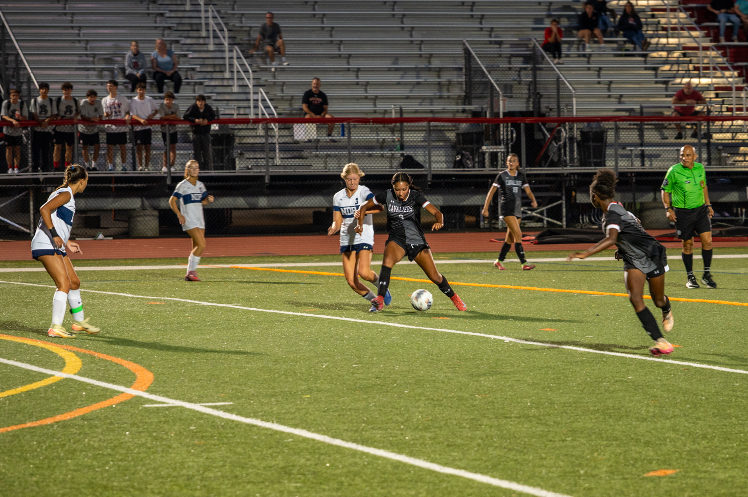 Notre Dame’s Stacey Giannopoulos and Spalding’s Karrington Gregory compete for...