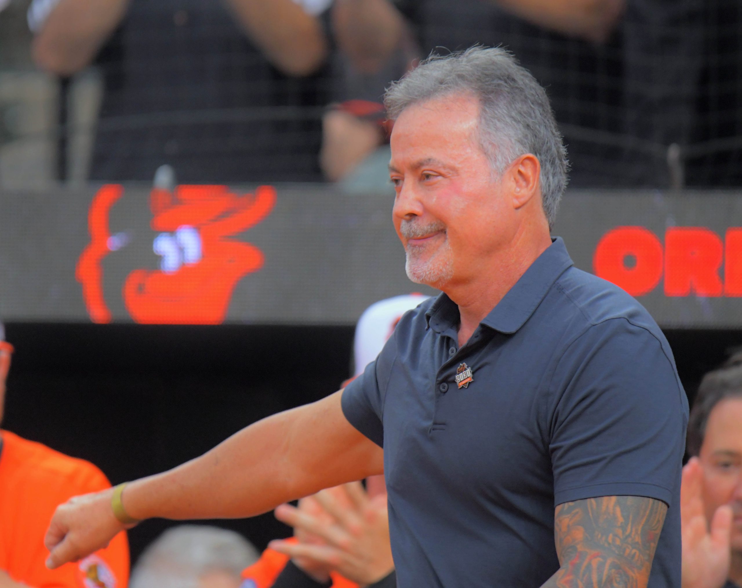 Former Baltimore Orioles player Rafael Palmeiro waves during a celebration...
