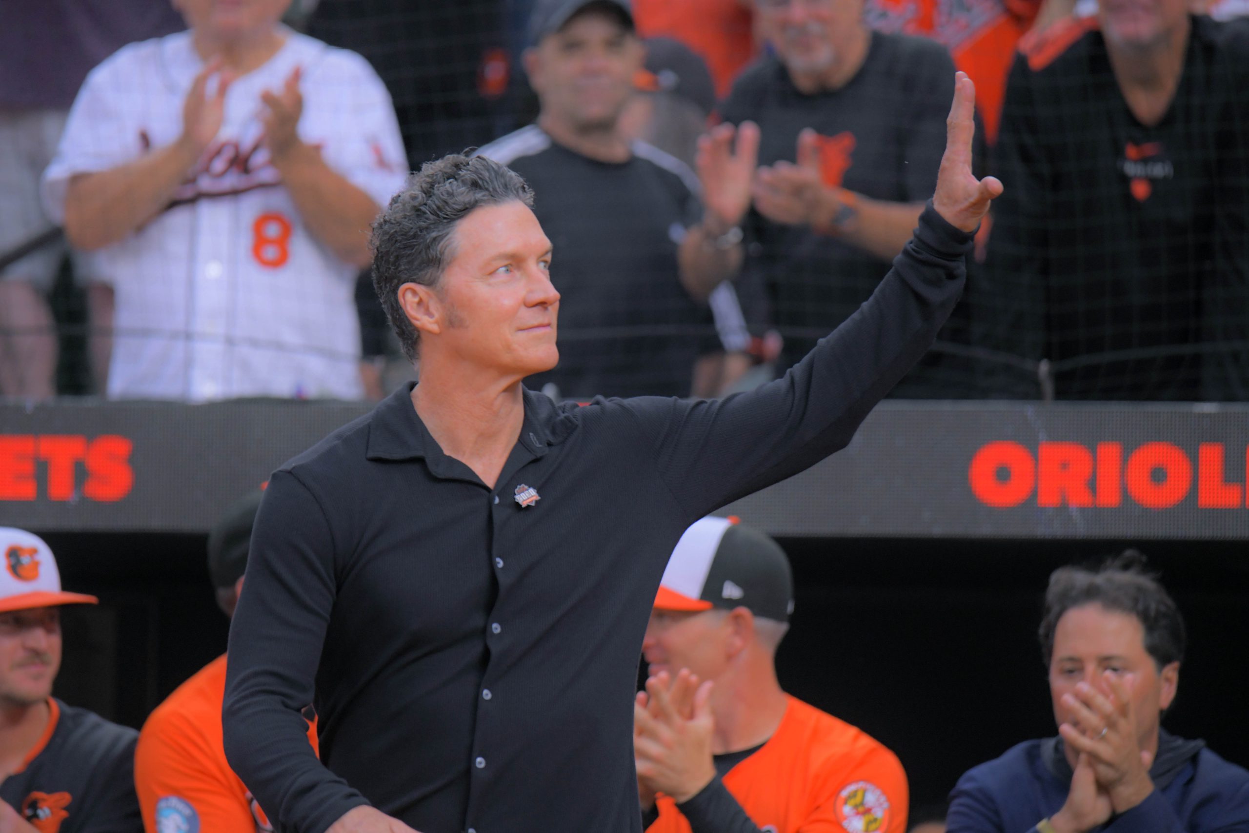 Former Baltimore Orioles player Brady Anderson waves during a celebration...