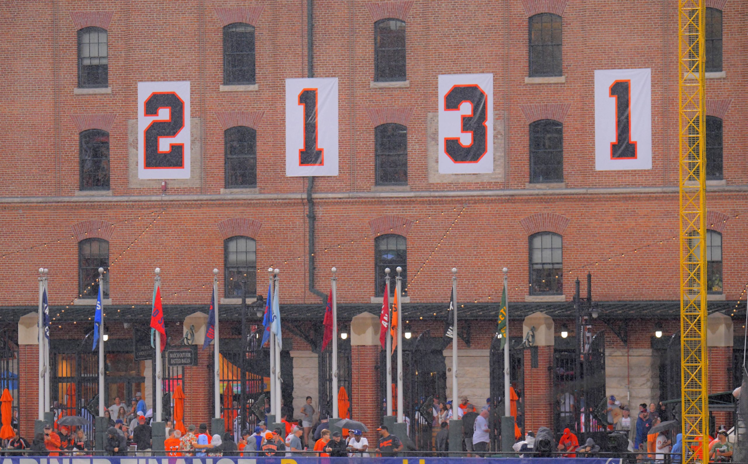 Fans walk beneath the historic numbers of 2,131 hanging outside...