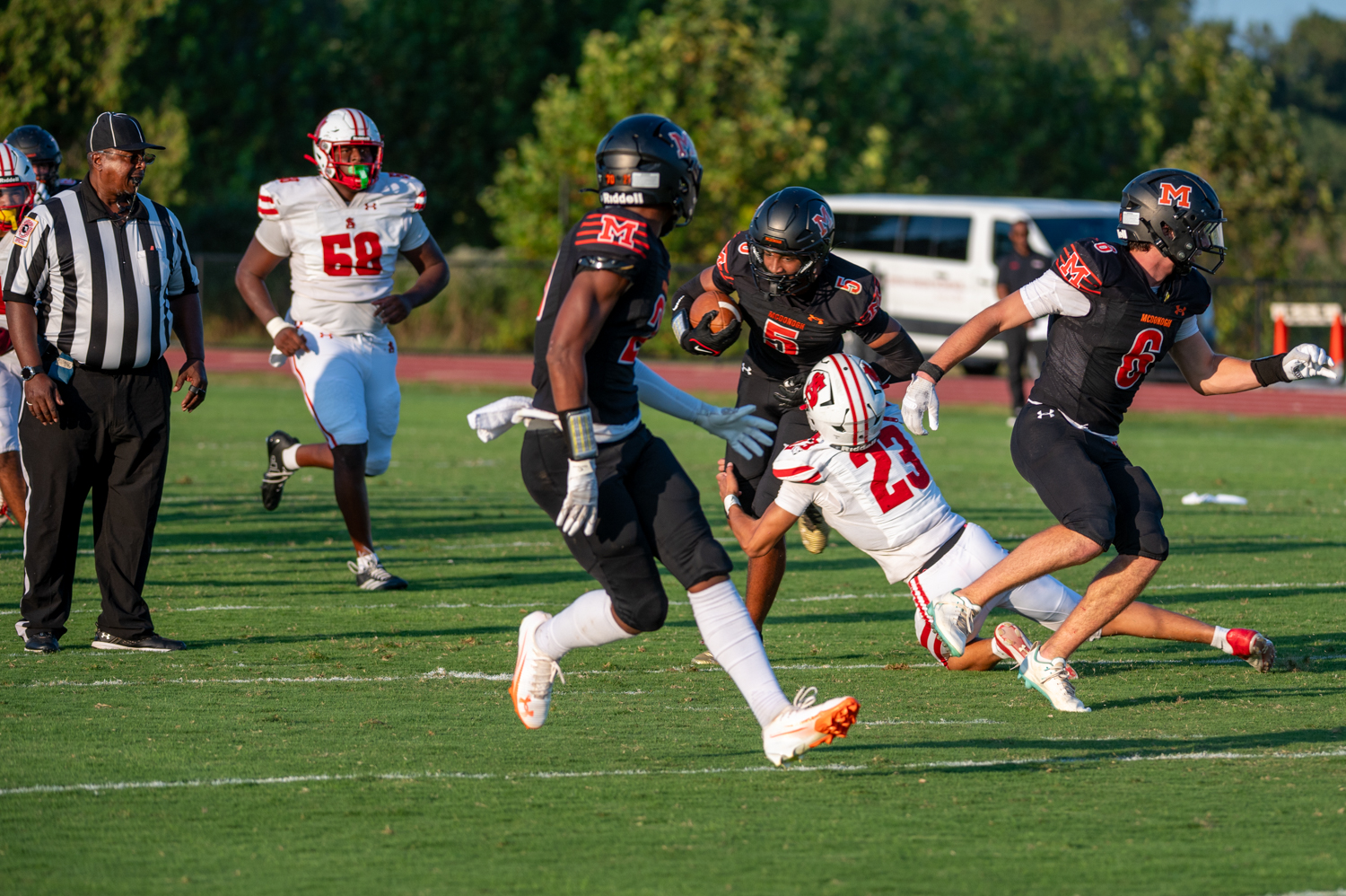 McDonogh wide receiver Carlos Ferguson takes a tackle from Spalding’s...