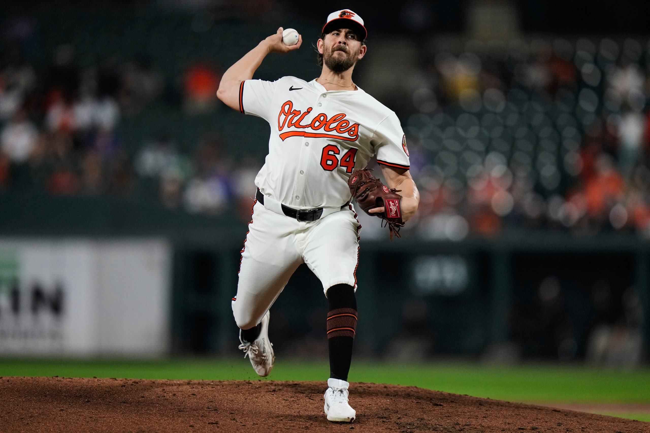 Baltimore Orioles starting pitcher Dean Kremer (64) delivers during the...