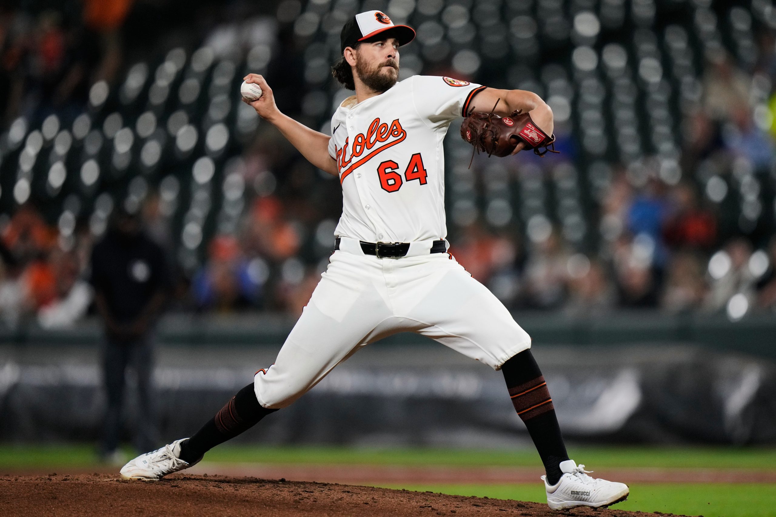 Baltimore Orioles starting pitcher Dean Kremer (64) delivers during the...