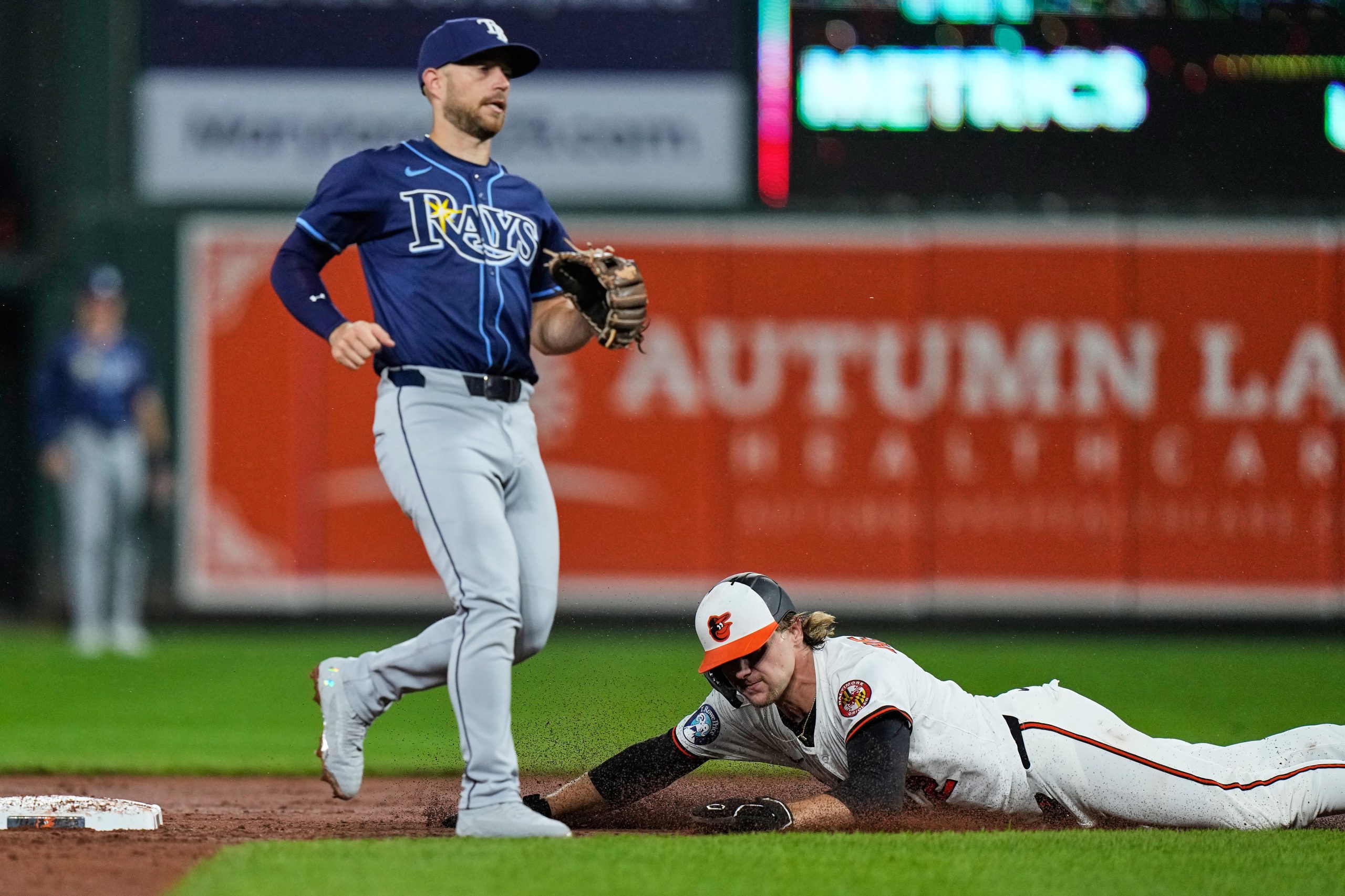 Baltimore Orioles' Gunnar Henderson, right, steals second base past Tampa...