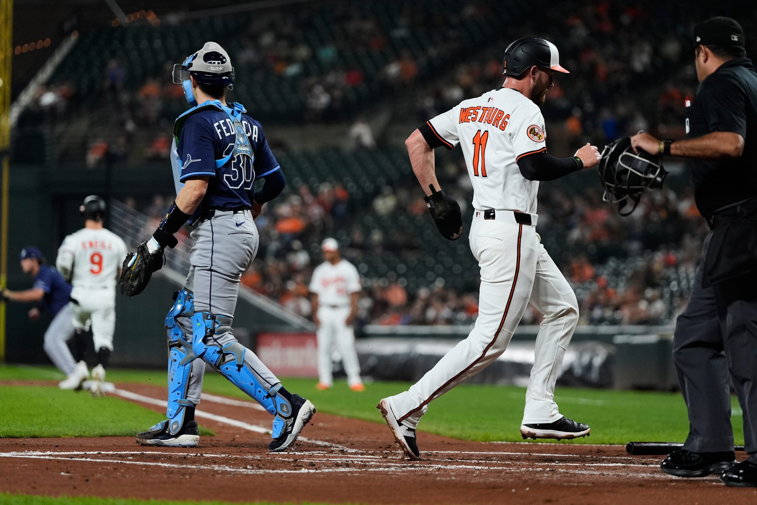Baltimore Orioles' Jordan Westburg (11) scores past Tampa Bay Rays...
