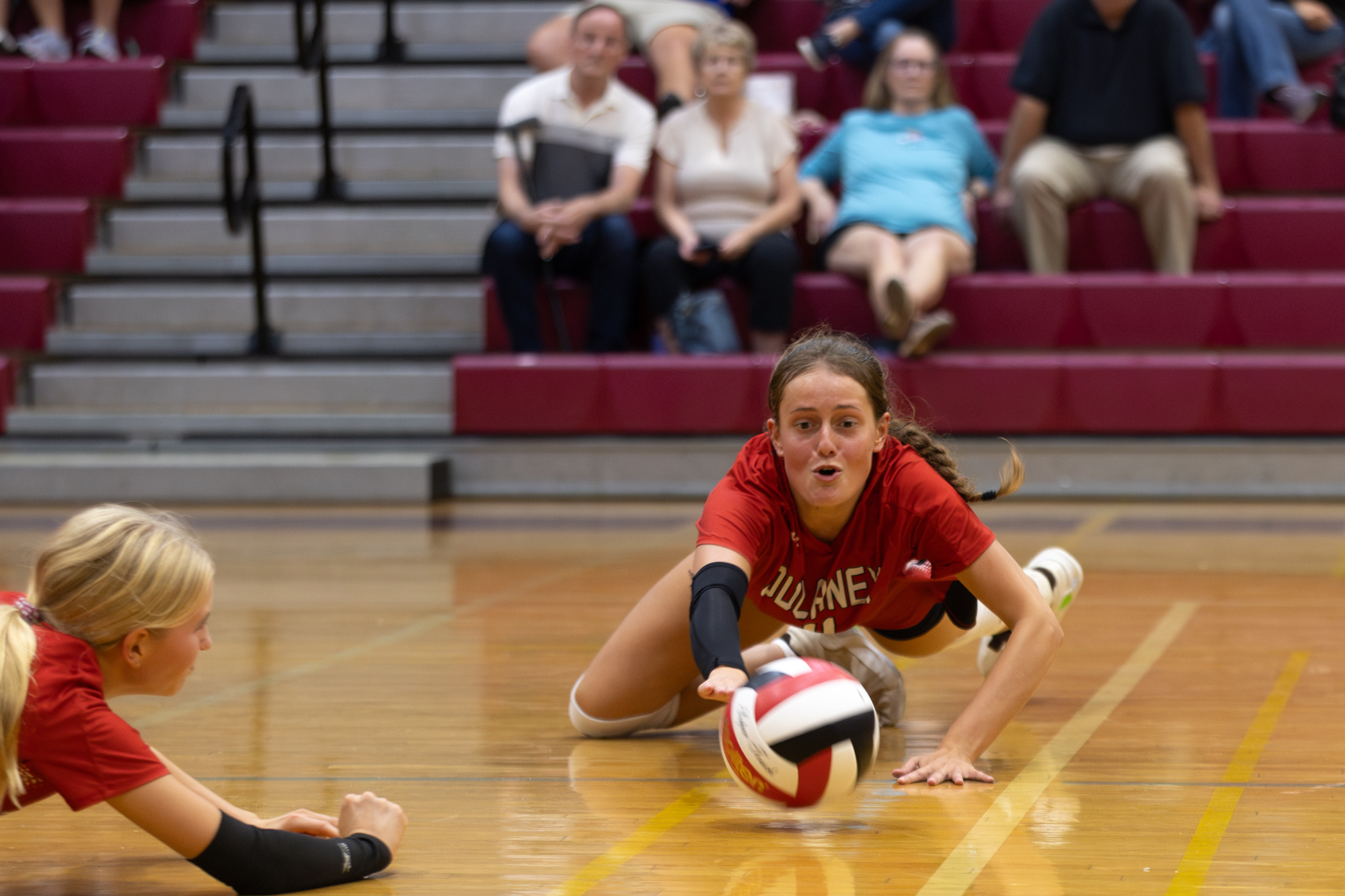 Dulaney’s Norah Buckingham, left, and Cami Reed dive for the...