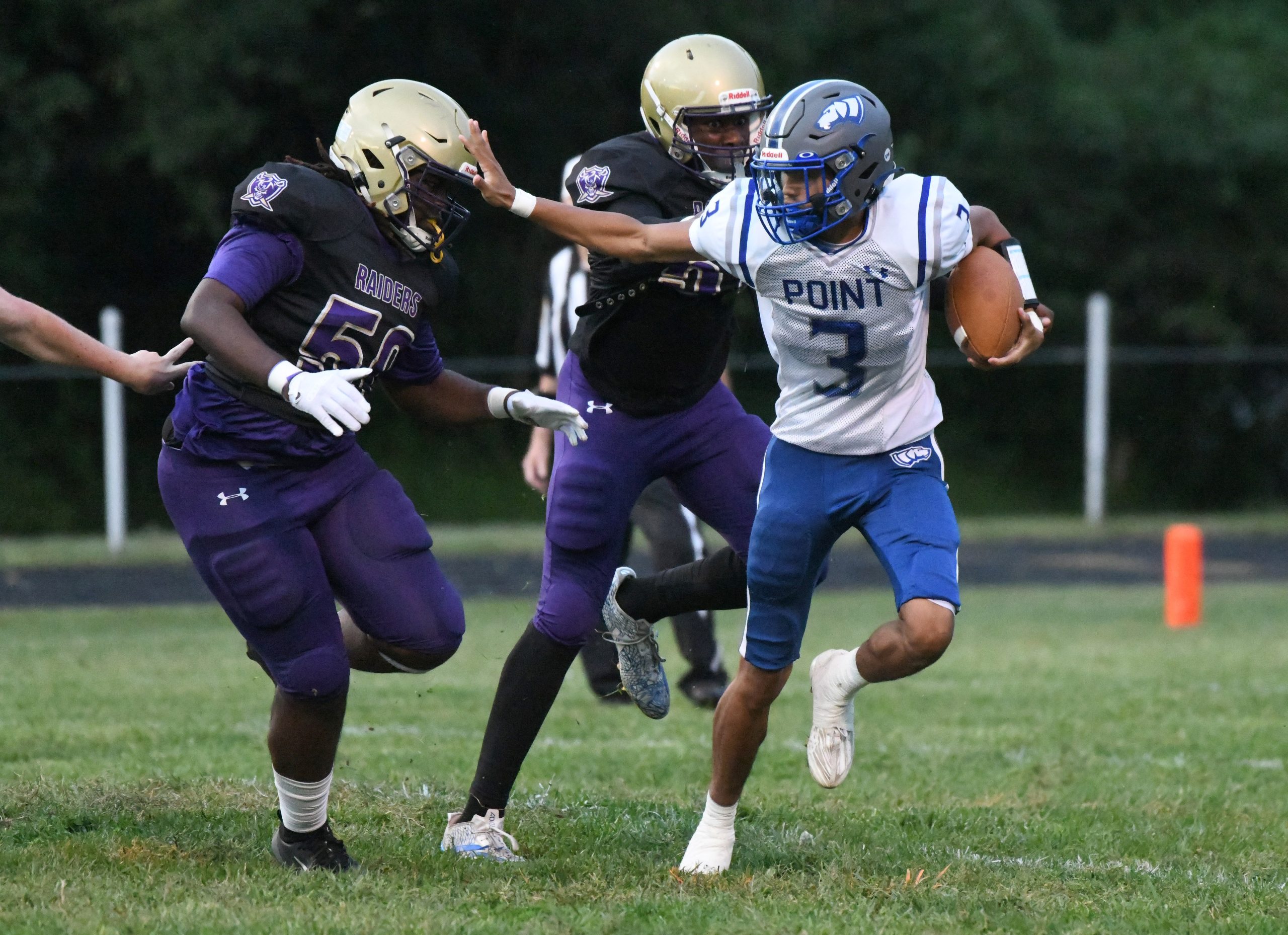 Sparrows Point quarterback Maceo Hardnett tries to escape pressure from...