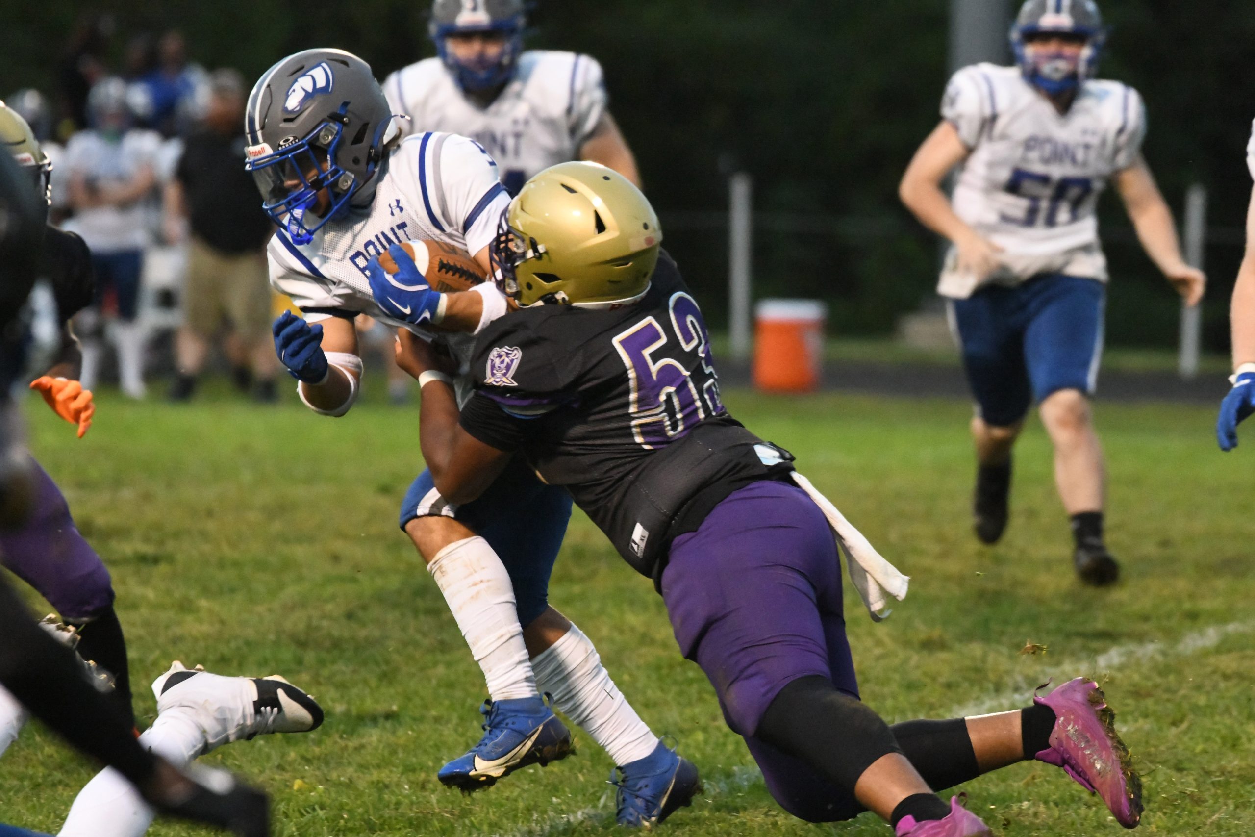 Sparrows Point's Mikey Maynor hangs on to the ball as...