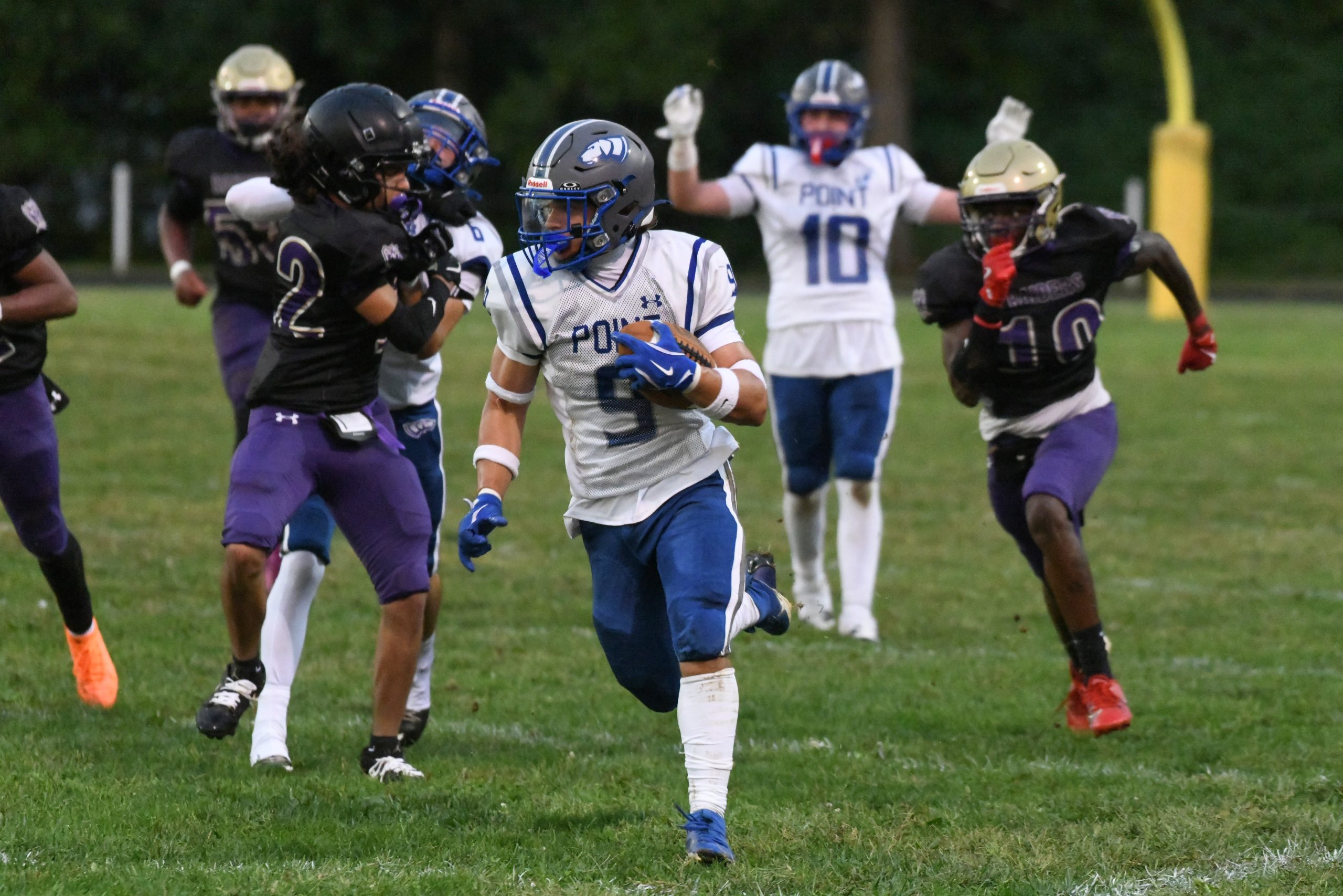 Sparrows Point's Mikey Maynor gains first down yardage on a...