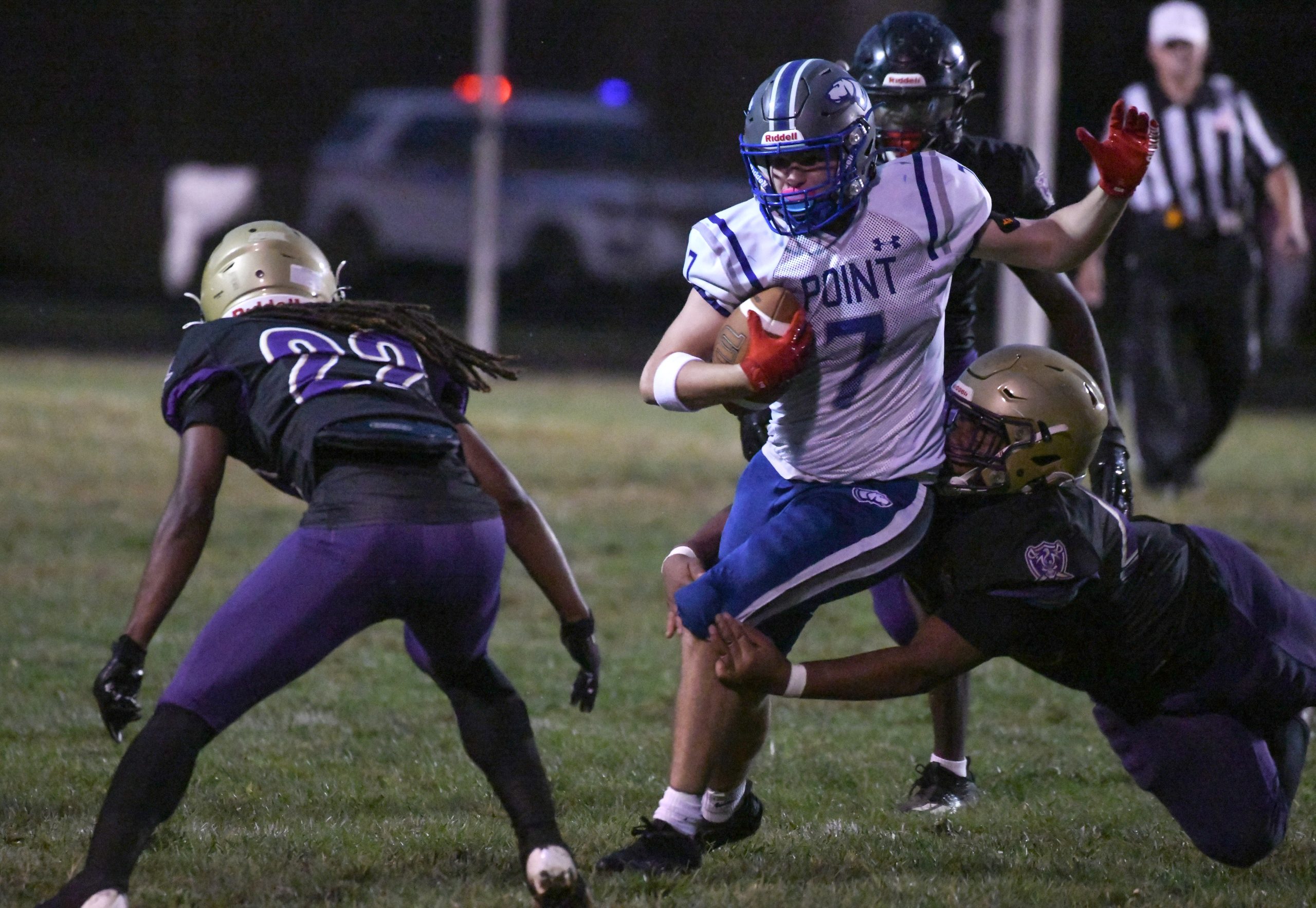 Sparrows Point's Paxton Clark tries to a escape a tackle...