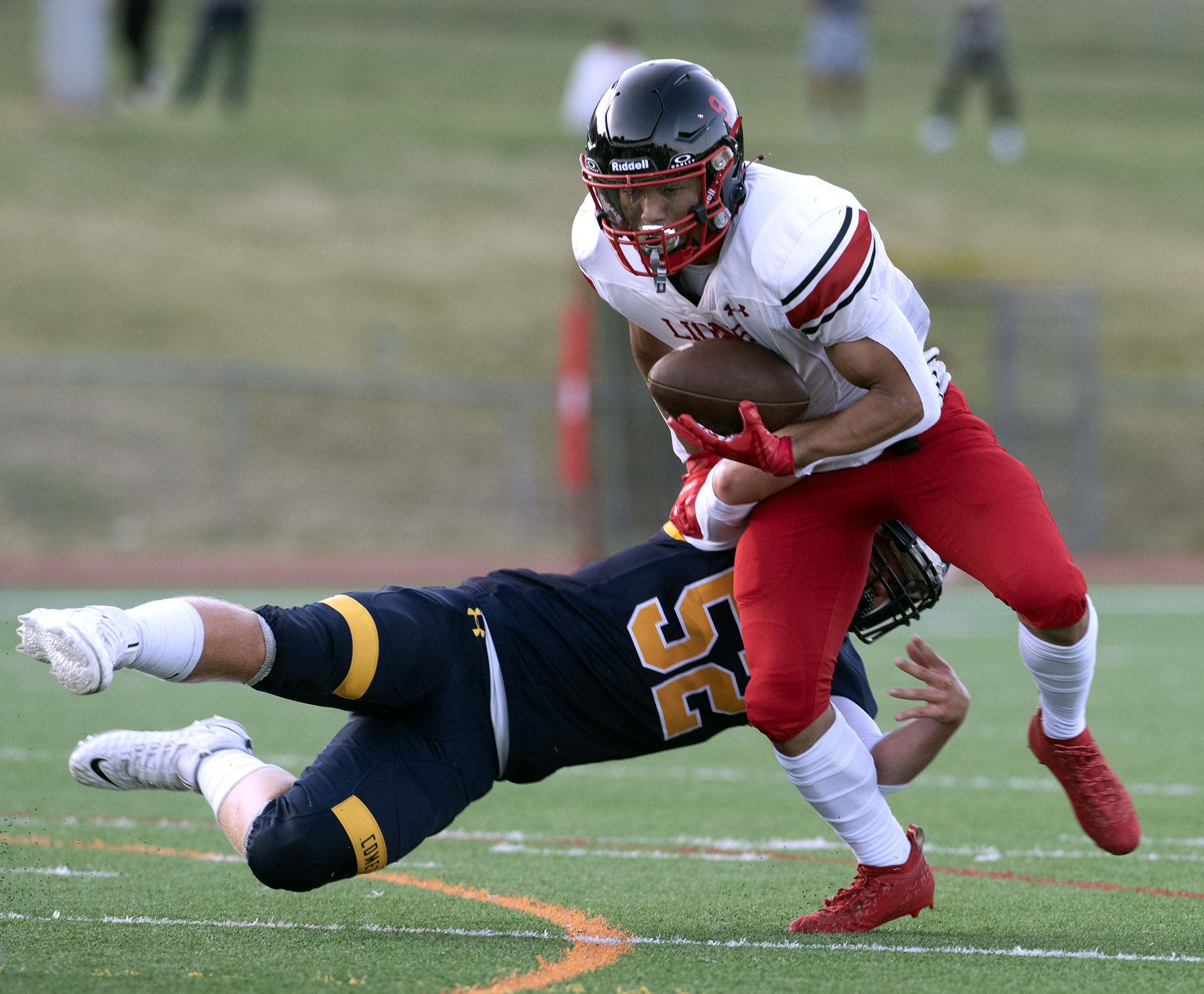 Dulaney's Gavin Nicholson carries the ball past Catonsville's Nate Smith....