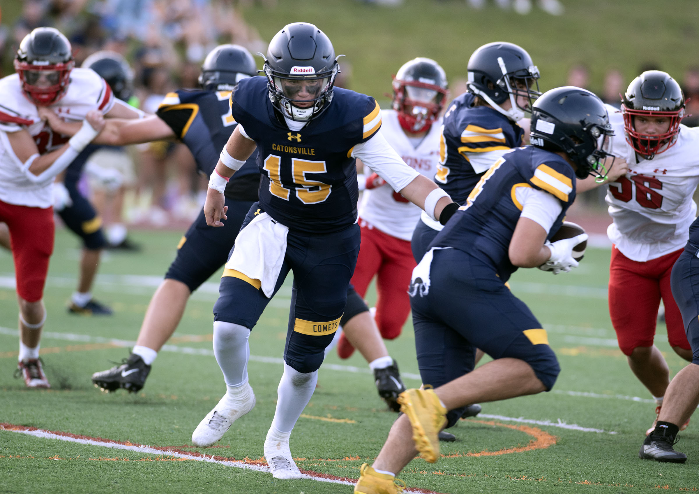 Sept. 12, 2025- Catonsville quarterback Evan Lindley hands off to...