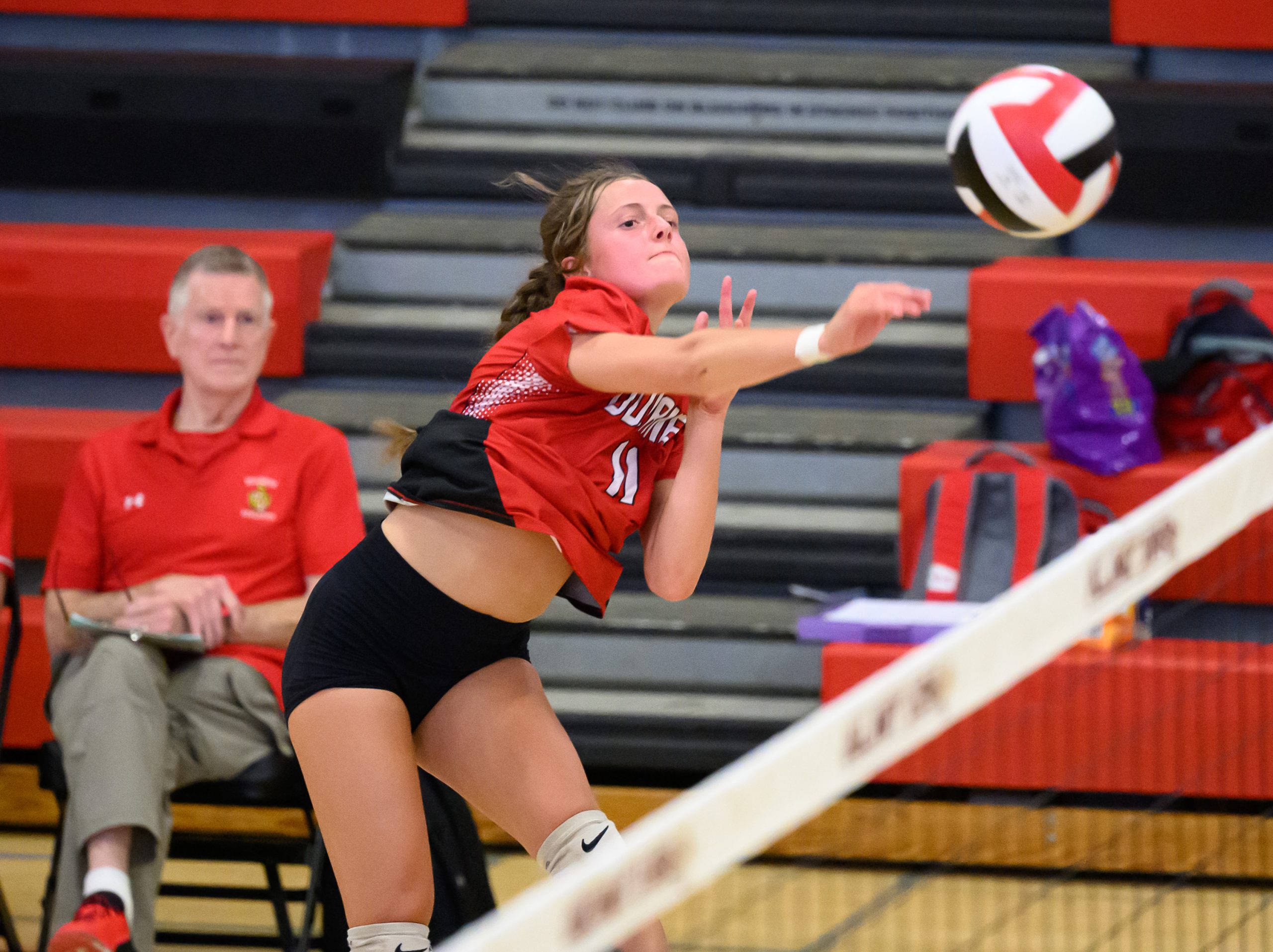 Dulaney’s Cami Reed hits a ball against Towson as her...