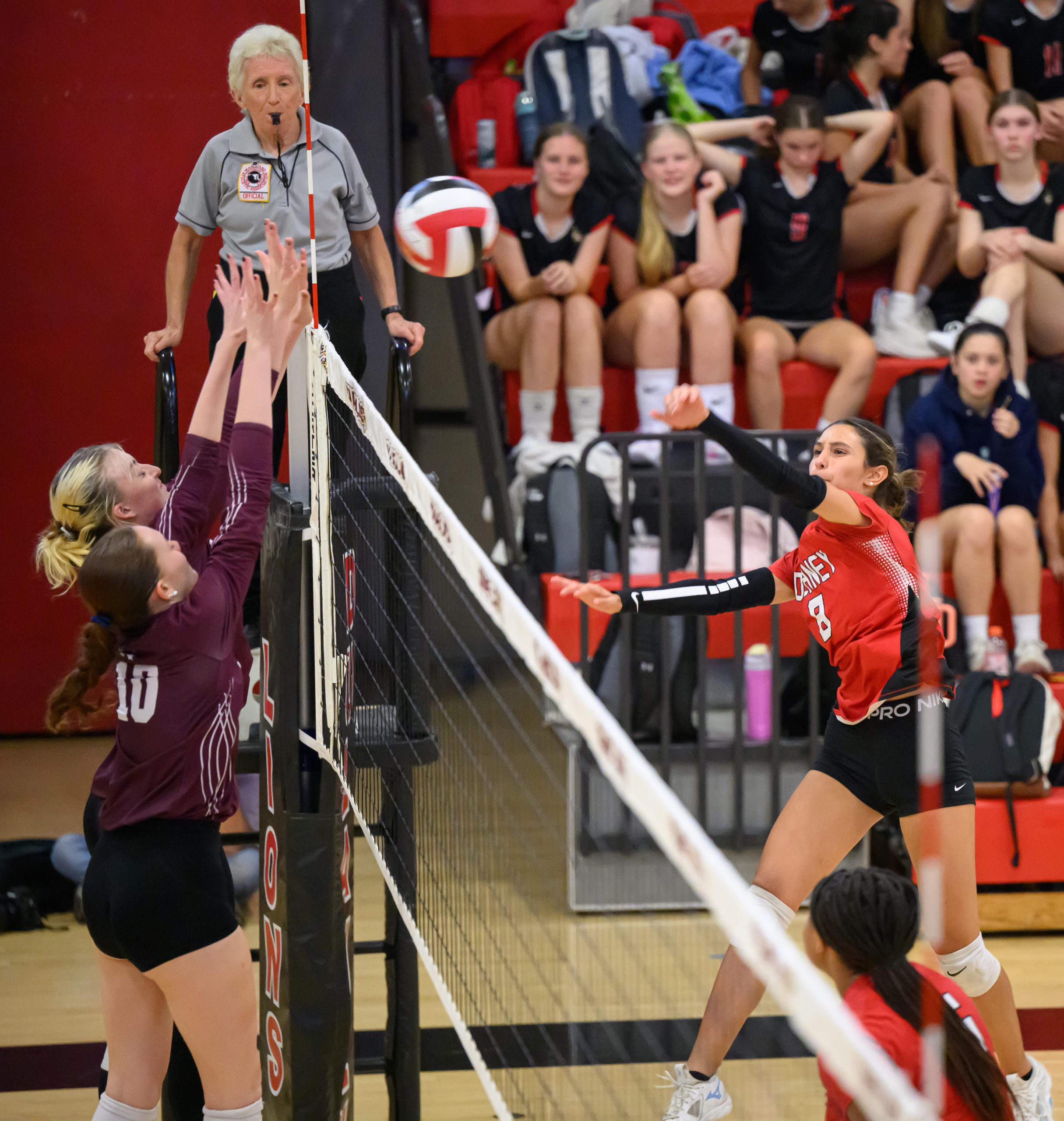 Dulaney’s Mia Koska, #8, hits a ball past Towson’s Shawna...