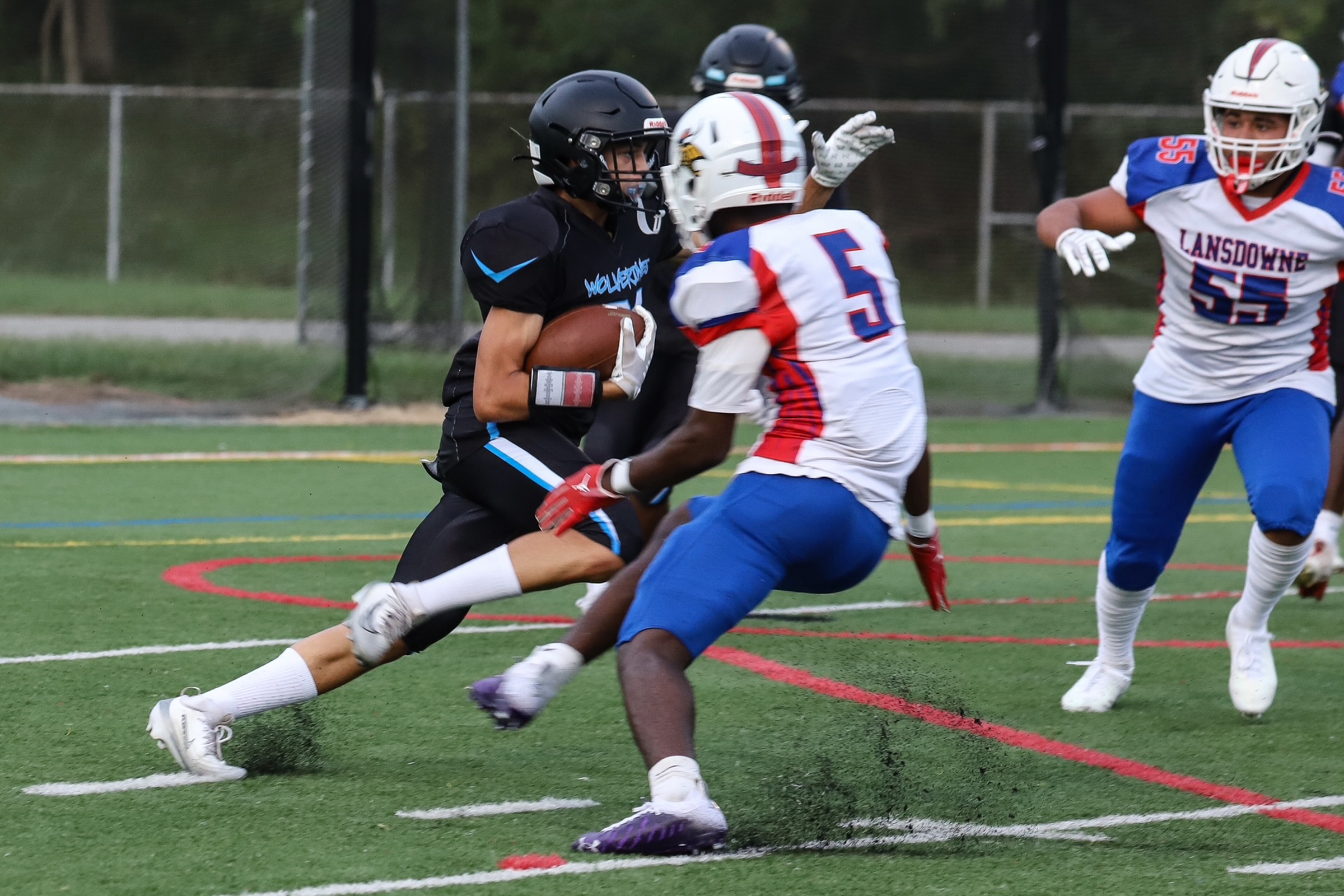 Western Tech’s wide receiver Dayquon Tarantino sidesteps past Lansdowne’s defensive...