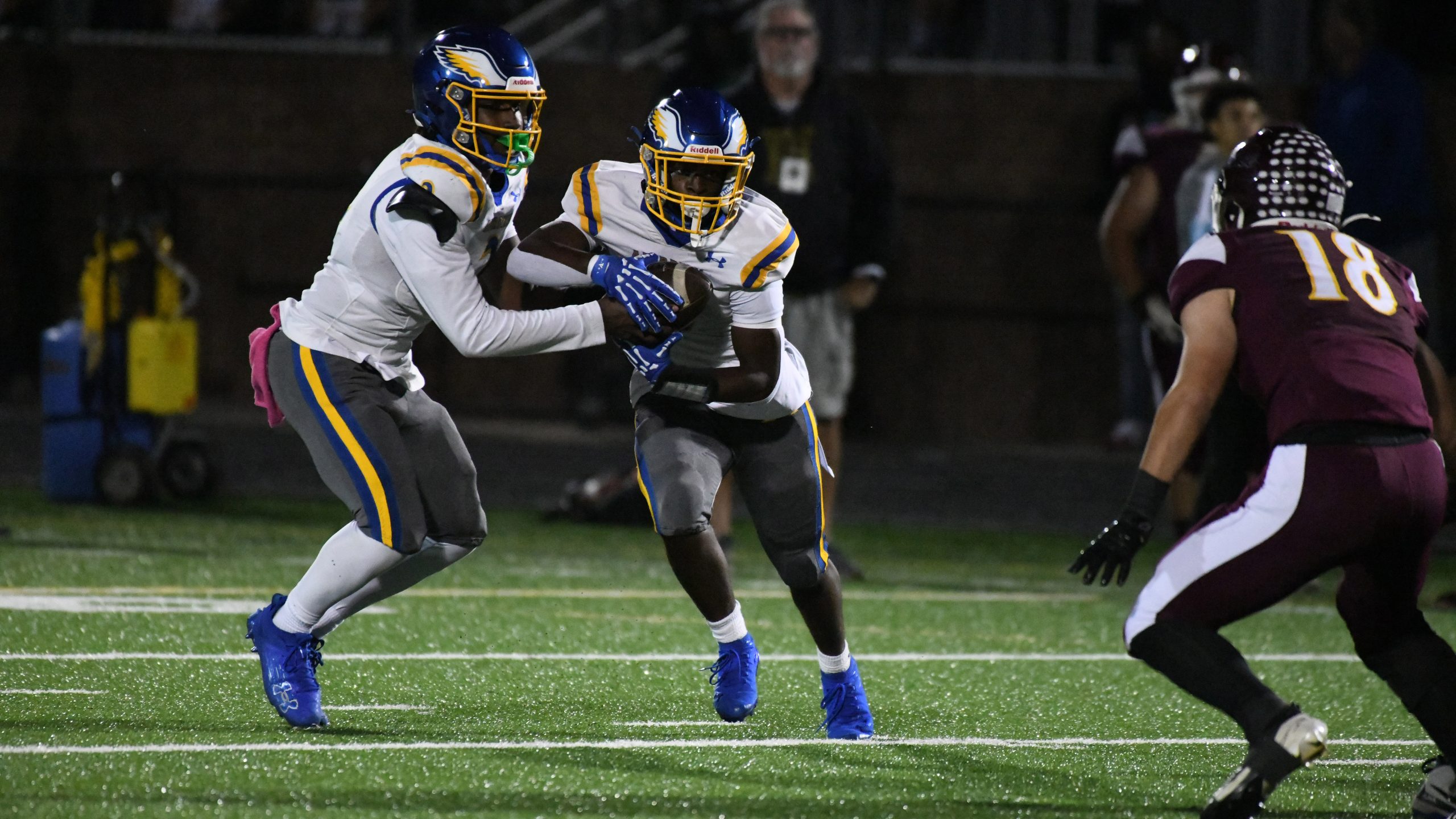 Aberdeen quarterback Collin Rogers hands off to running back Cameron...
