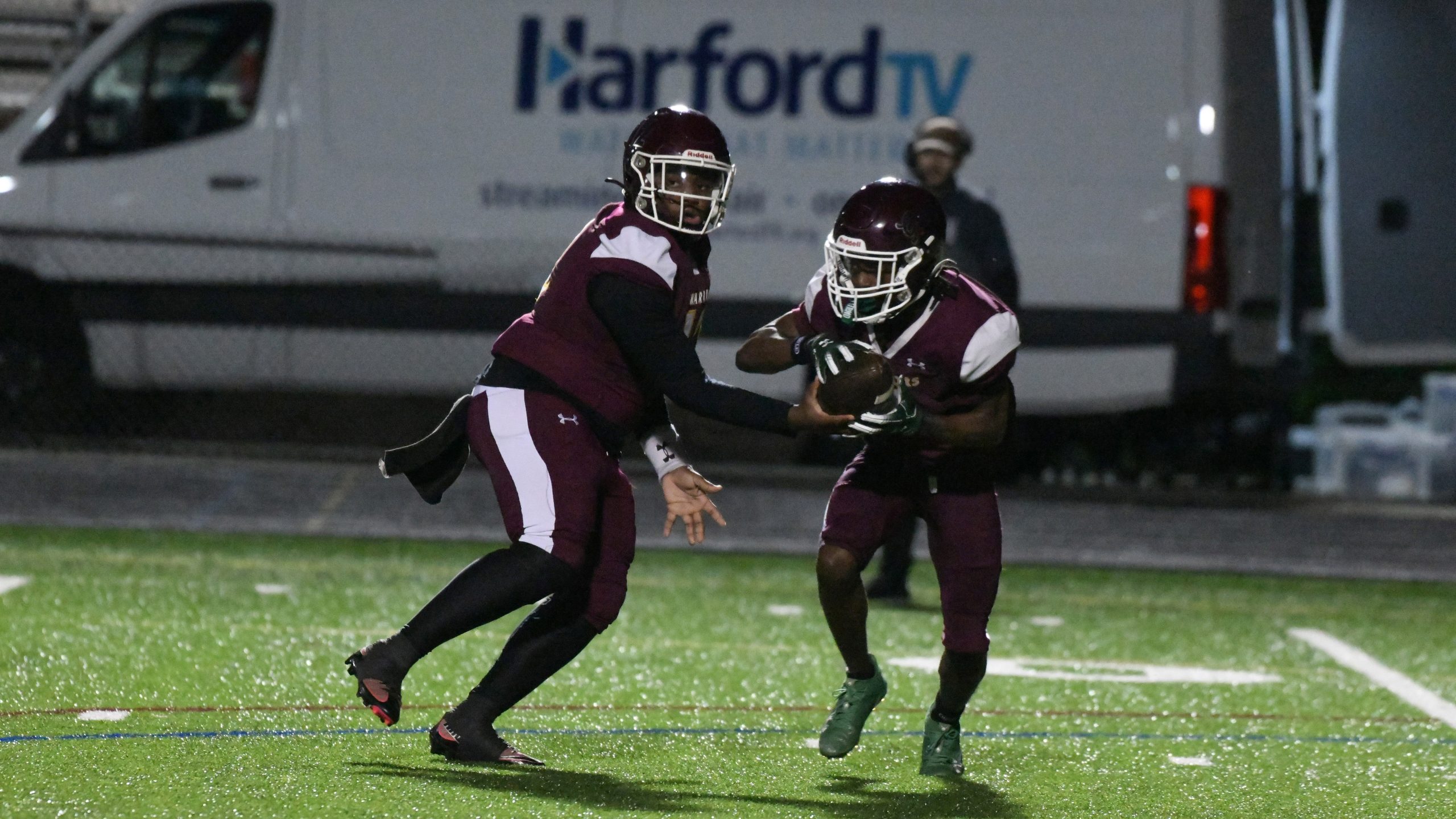 Havre de Grace quarterback Julian Ringgold hands off to running...