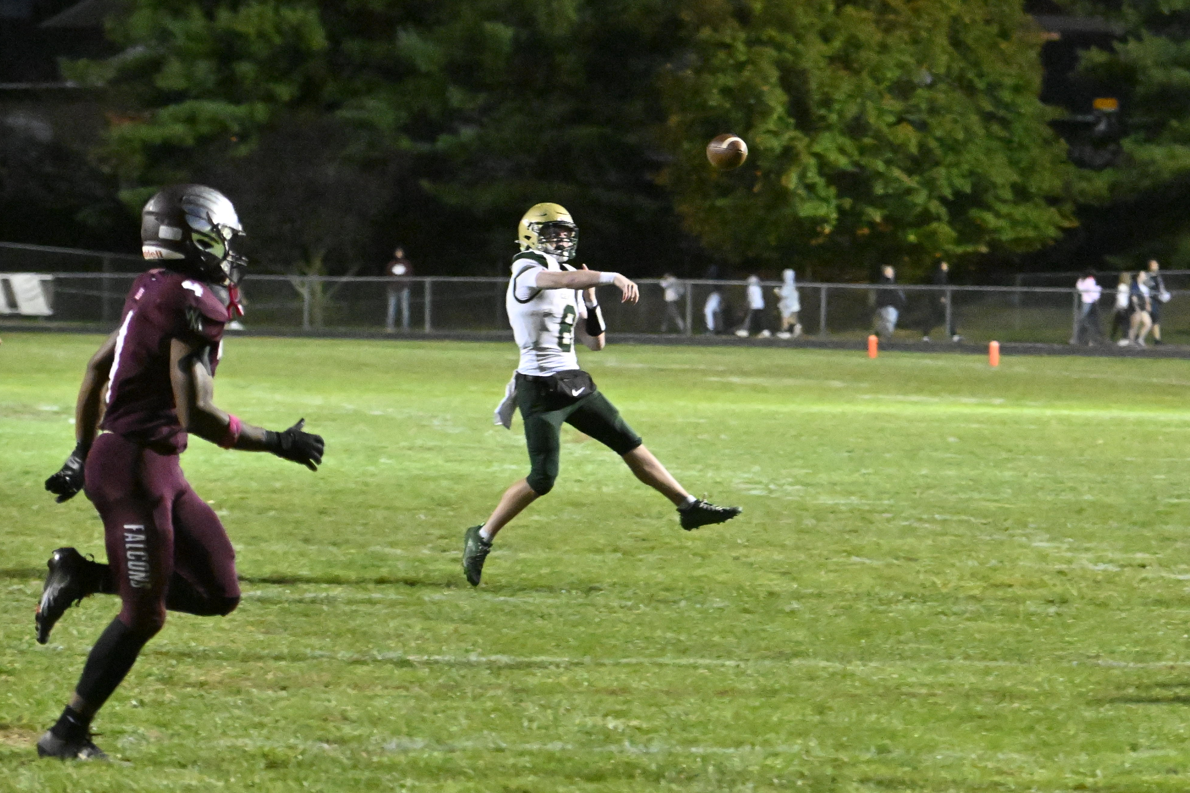 Century's Jacob Dexter passes the ball during a football game...