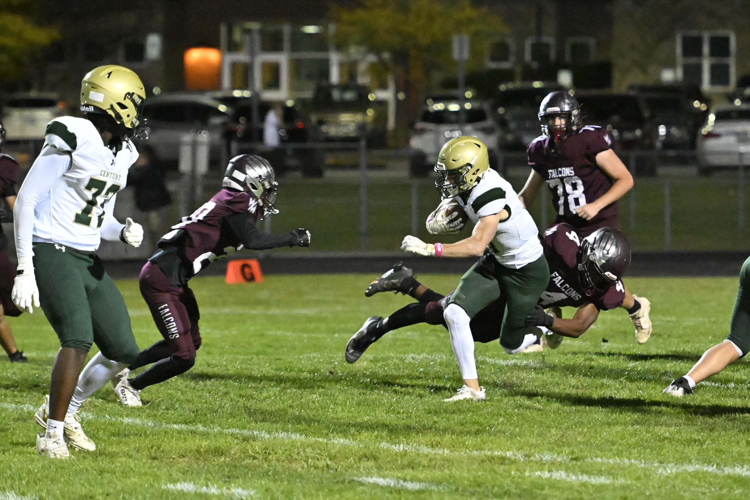 Century's William Koenig is brought down by Jarell Baker as...
