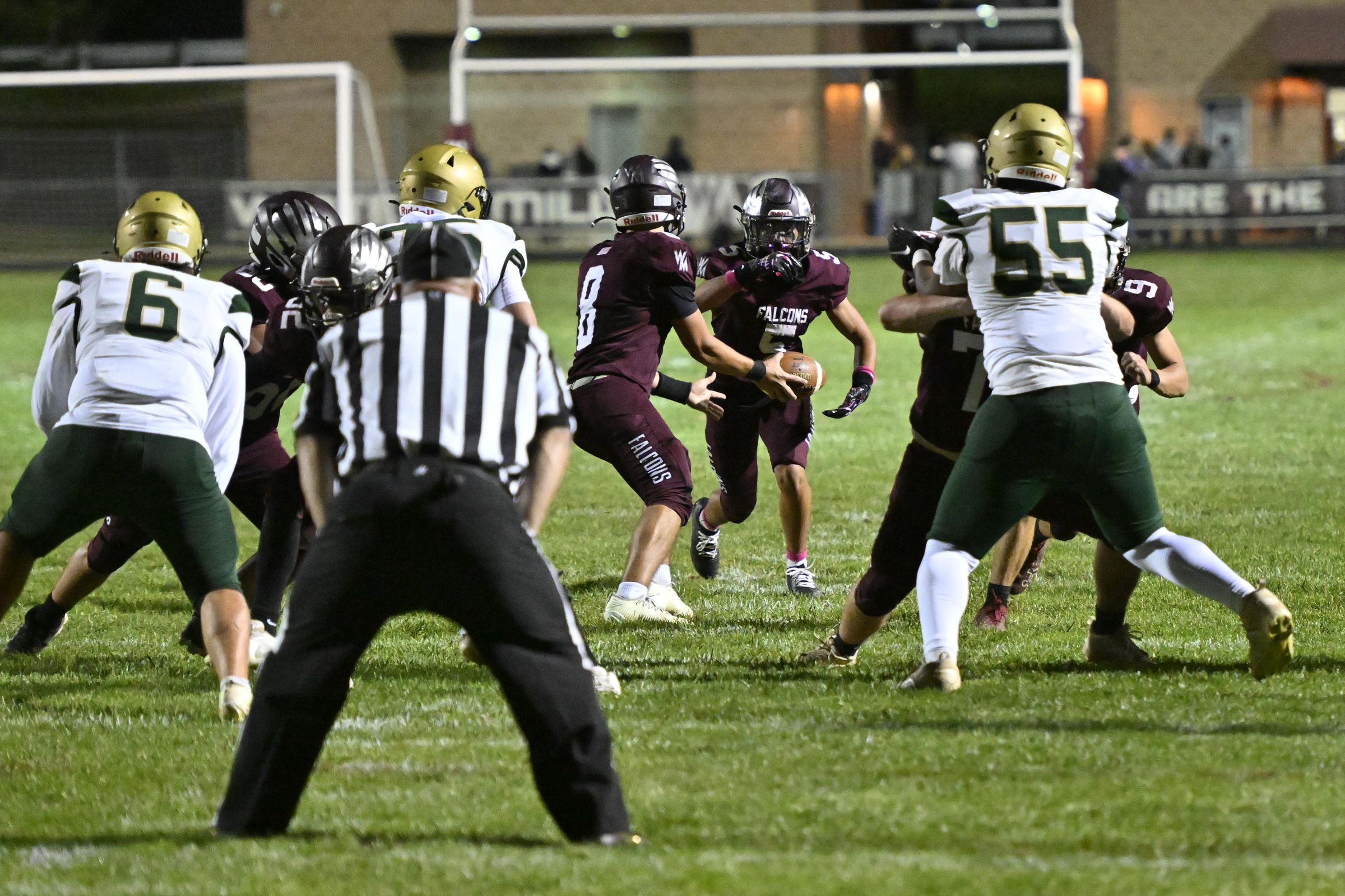 Austin Denning hands the ball off to Jake Andolina during...