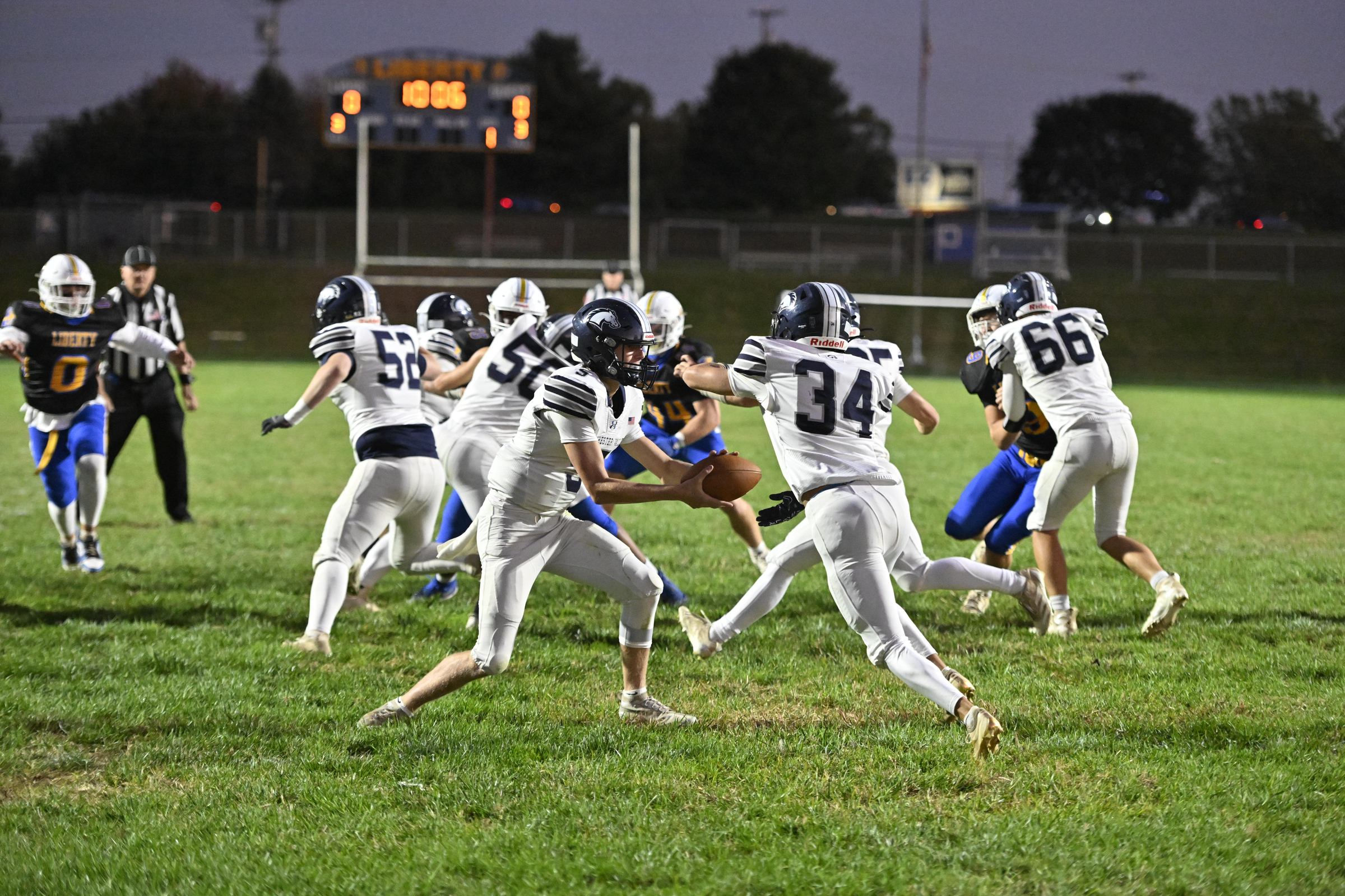 Manchester Valley's Beau Snell hands the ball off to Connor...