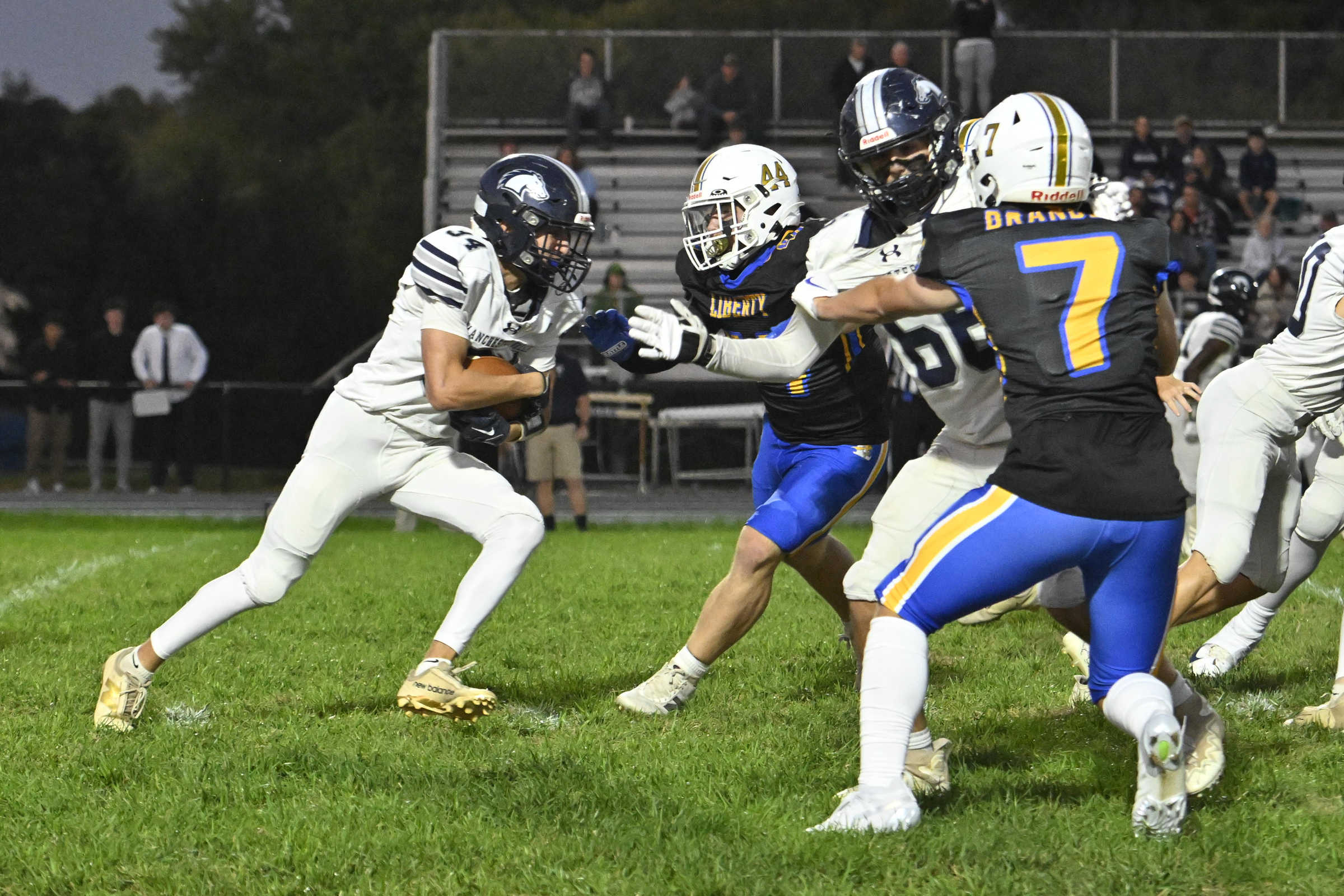 Manchester Valley's Connor Stack runs the ball during a football...