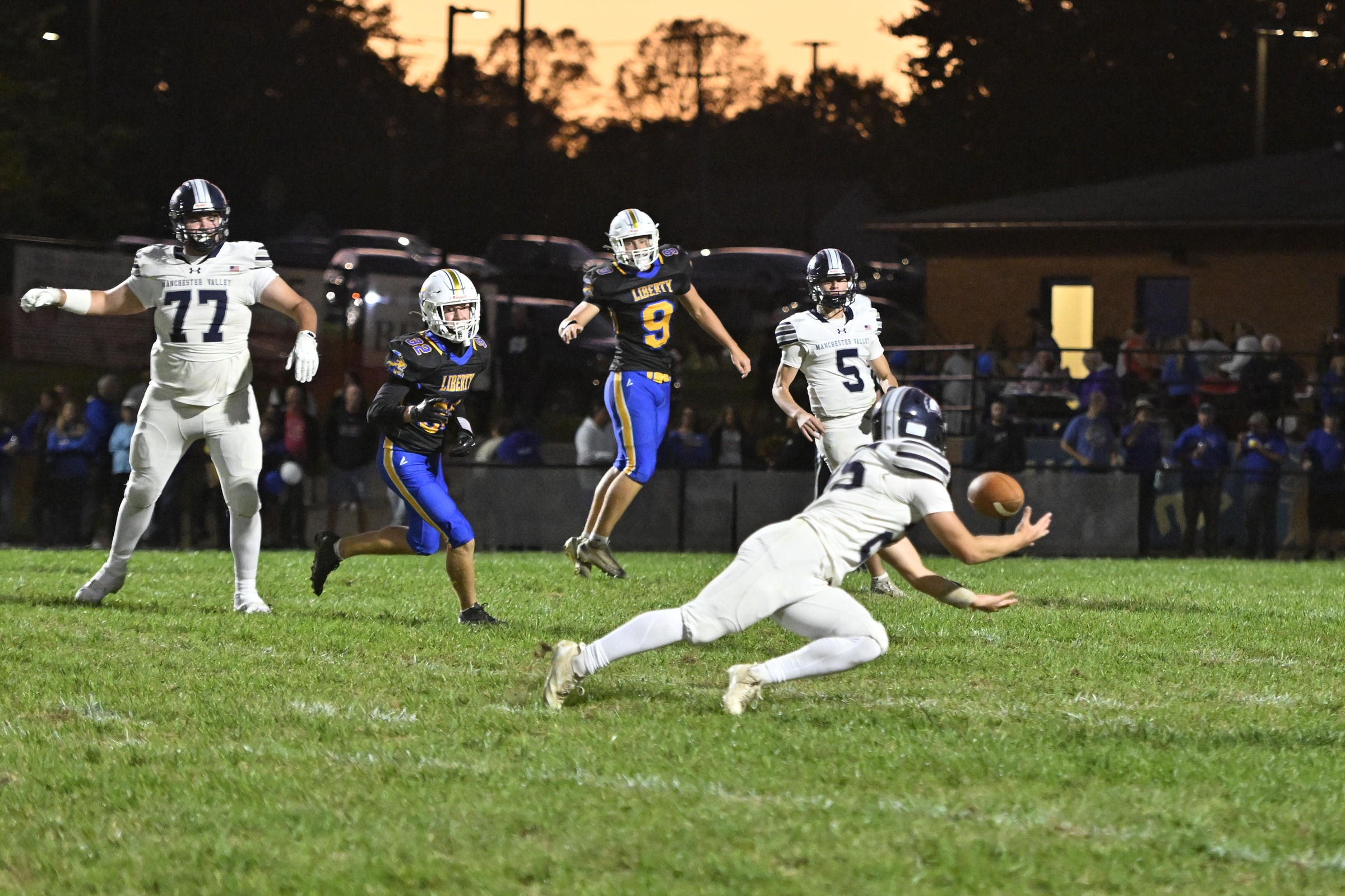 Manchester Valley's John Day catches a pass during a football...