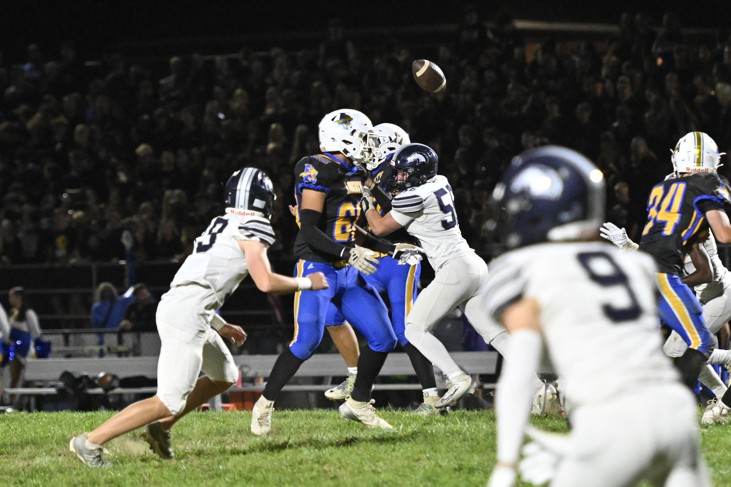 Manchester Valley's Robert Hummel hits quarterback Sean Case causing an...