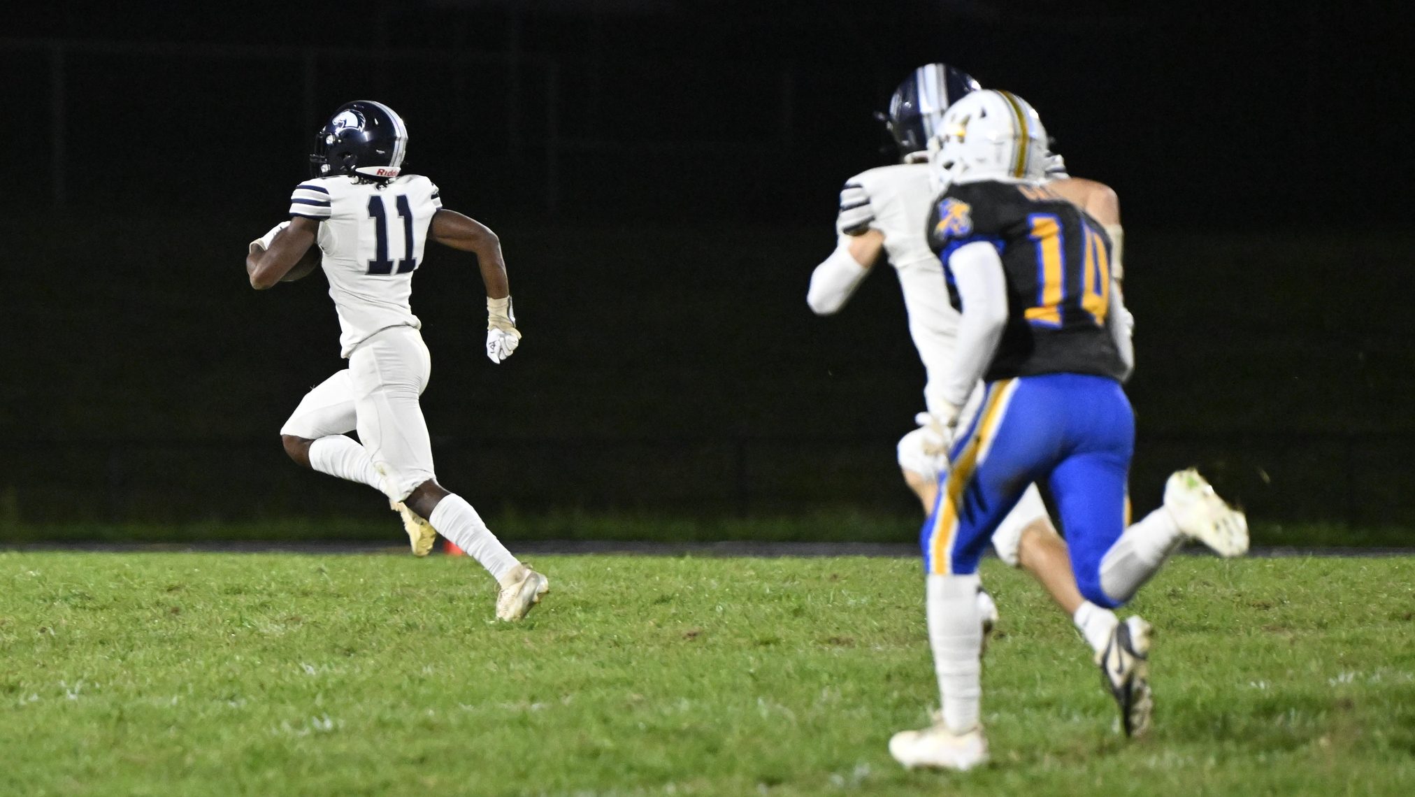 Manchester Valley's Walter Sallee runs for a touchdown after intercepting...